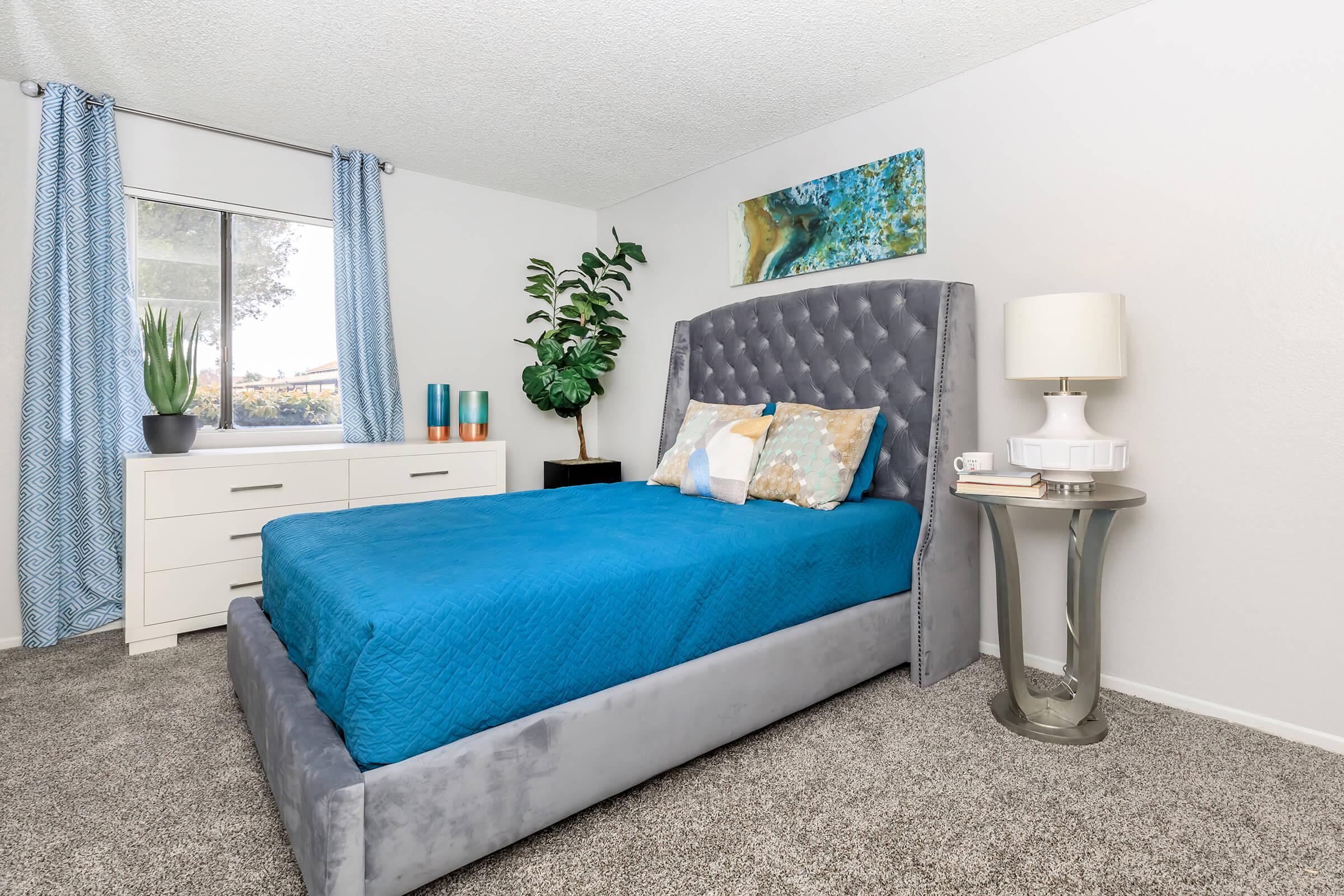Furnished bedroom with blue sheets