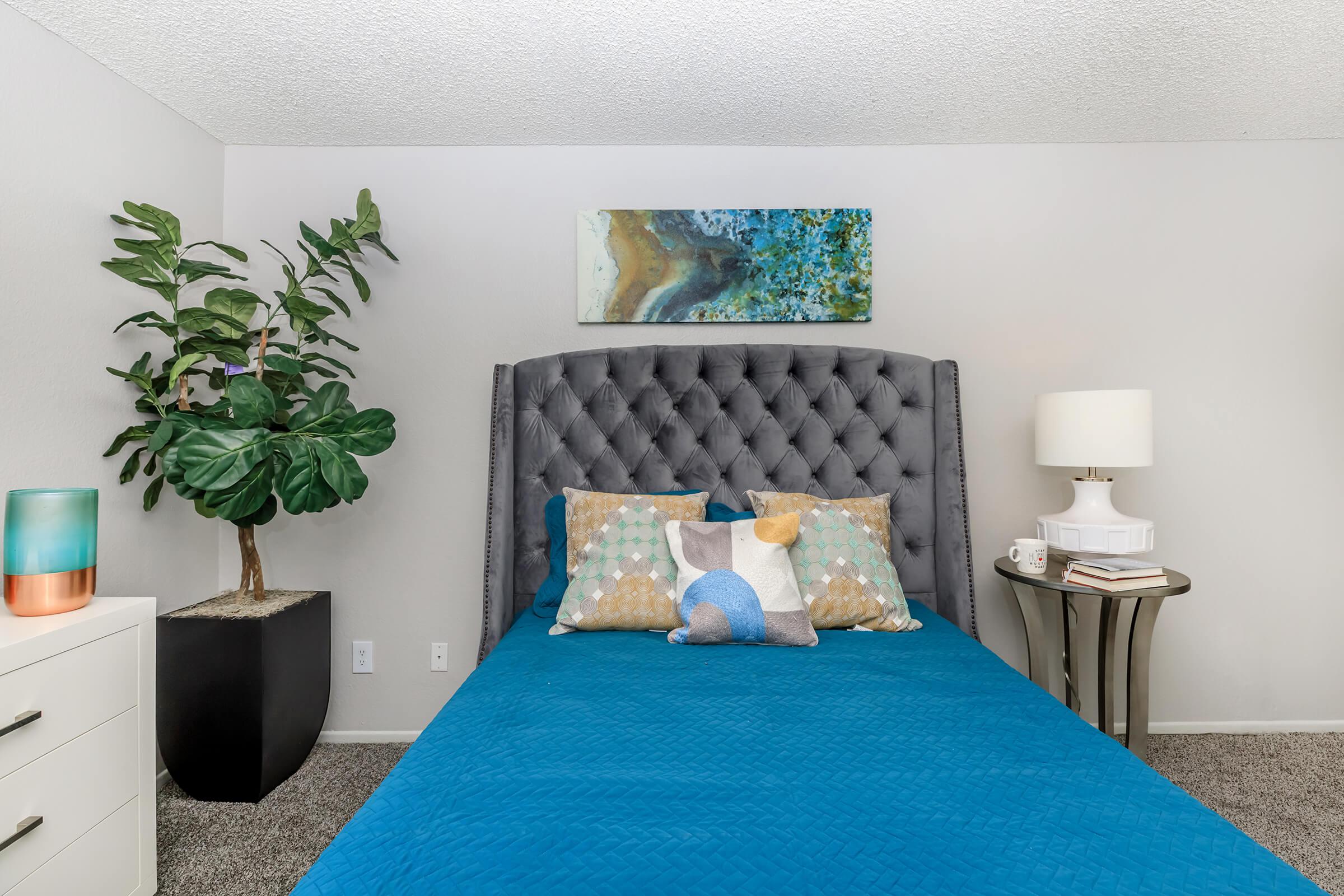 Bedroom with blue and orange throw pillows