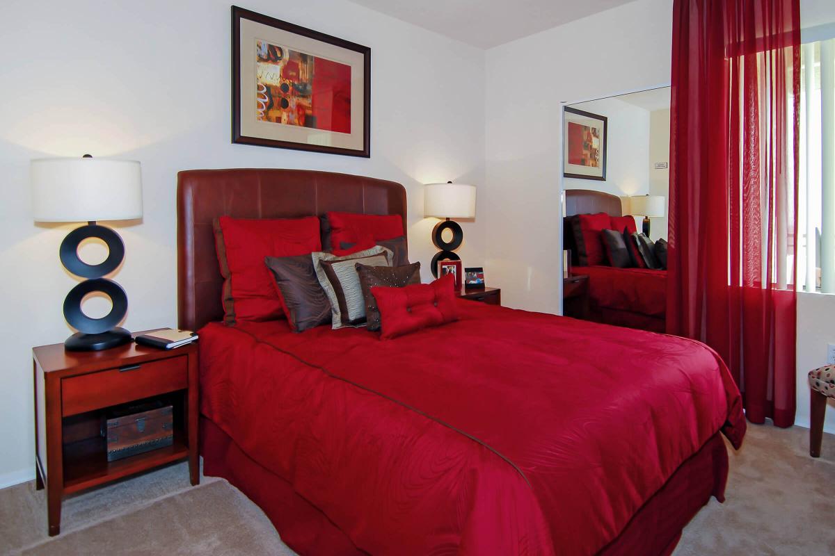 a bedroom with a large red chair in a room
