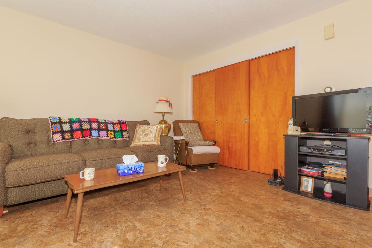 a living room filled with furniture and a wood floor