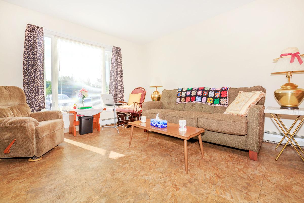 a living room filled with furniture and a fireplace