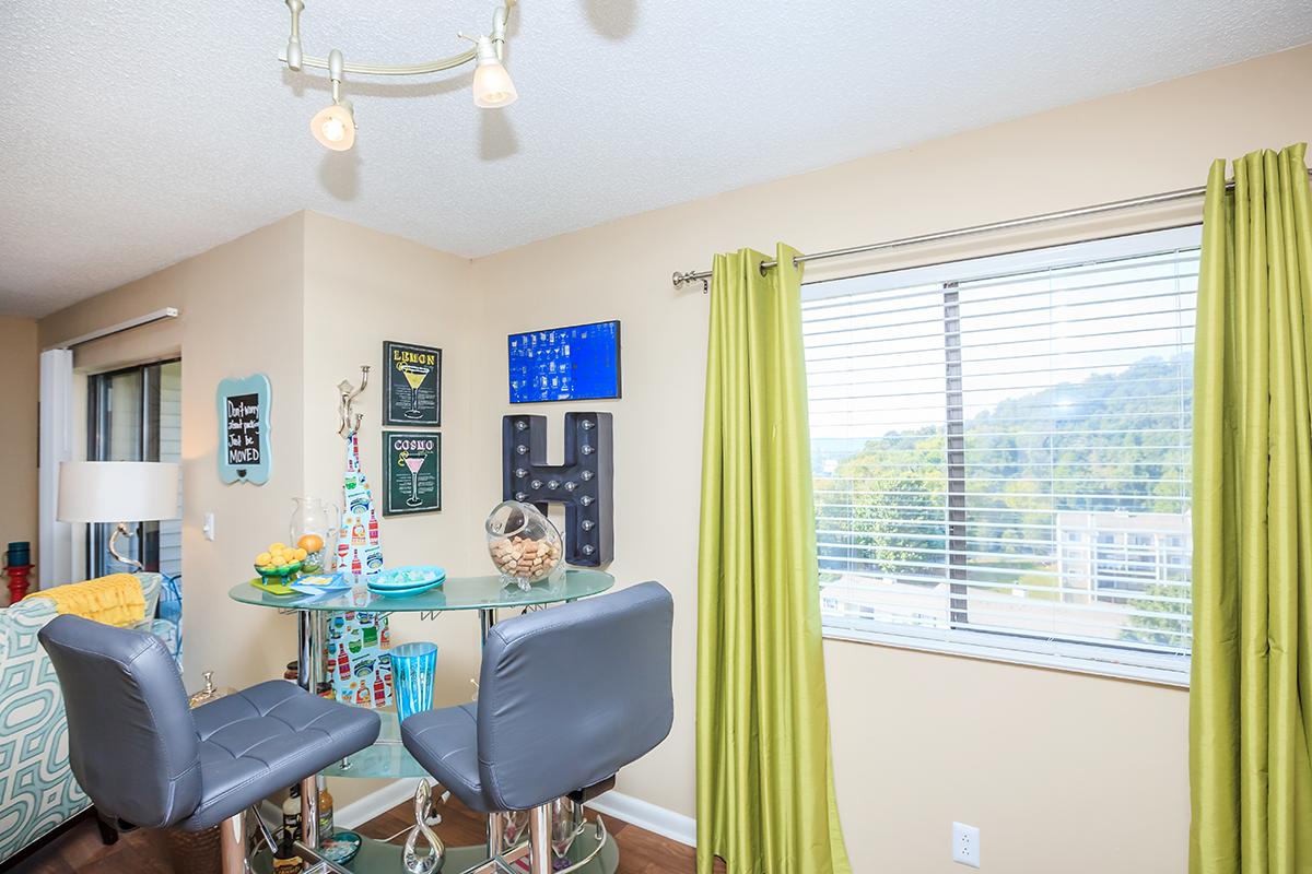 a living room filled with furniture and a large window