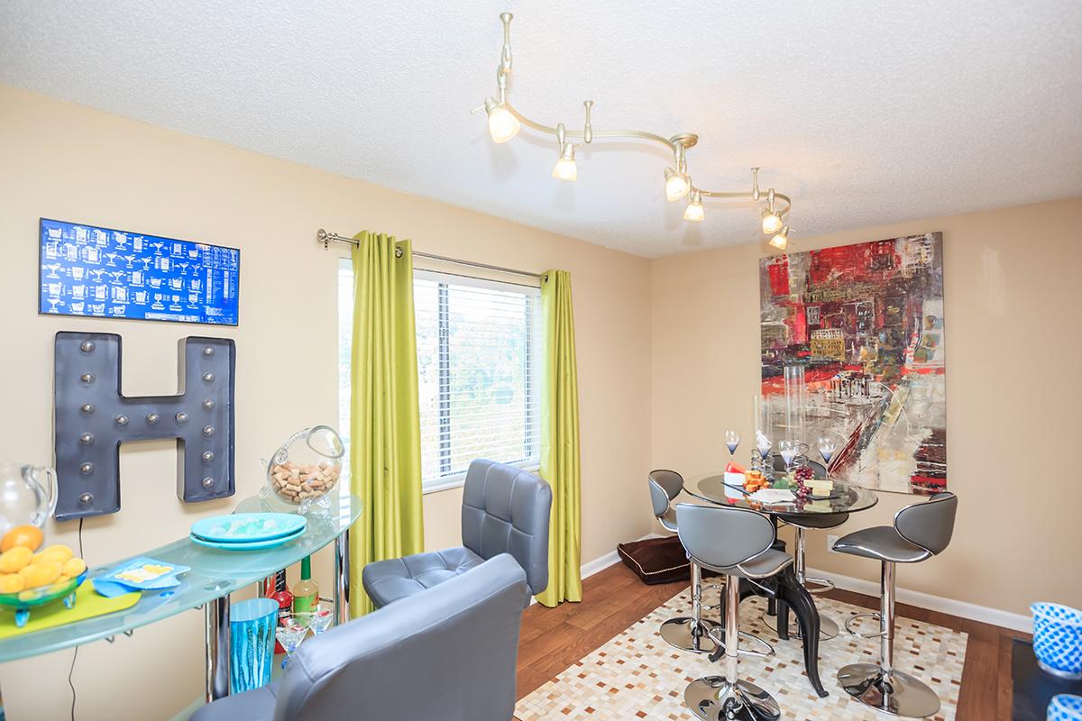 a living room filled with furniture and a flat screen tv