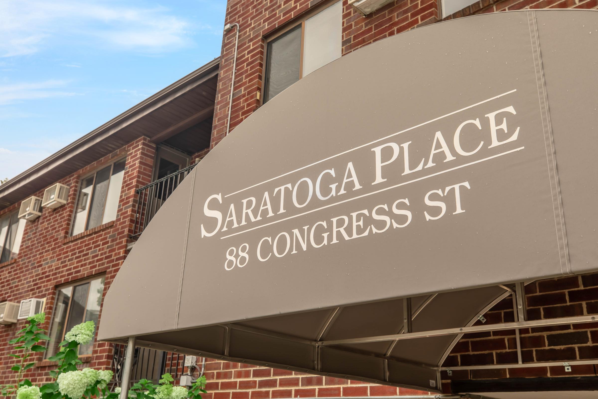 a sign above a storefront on a brick building