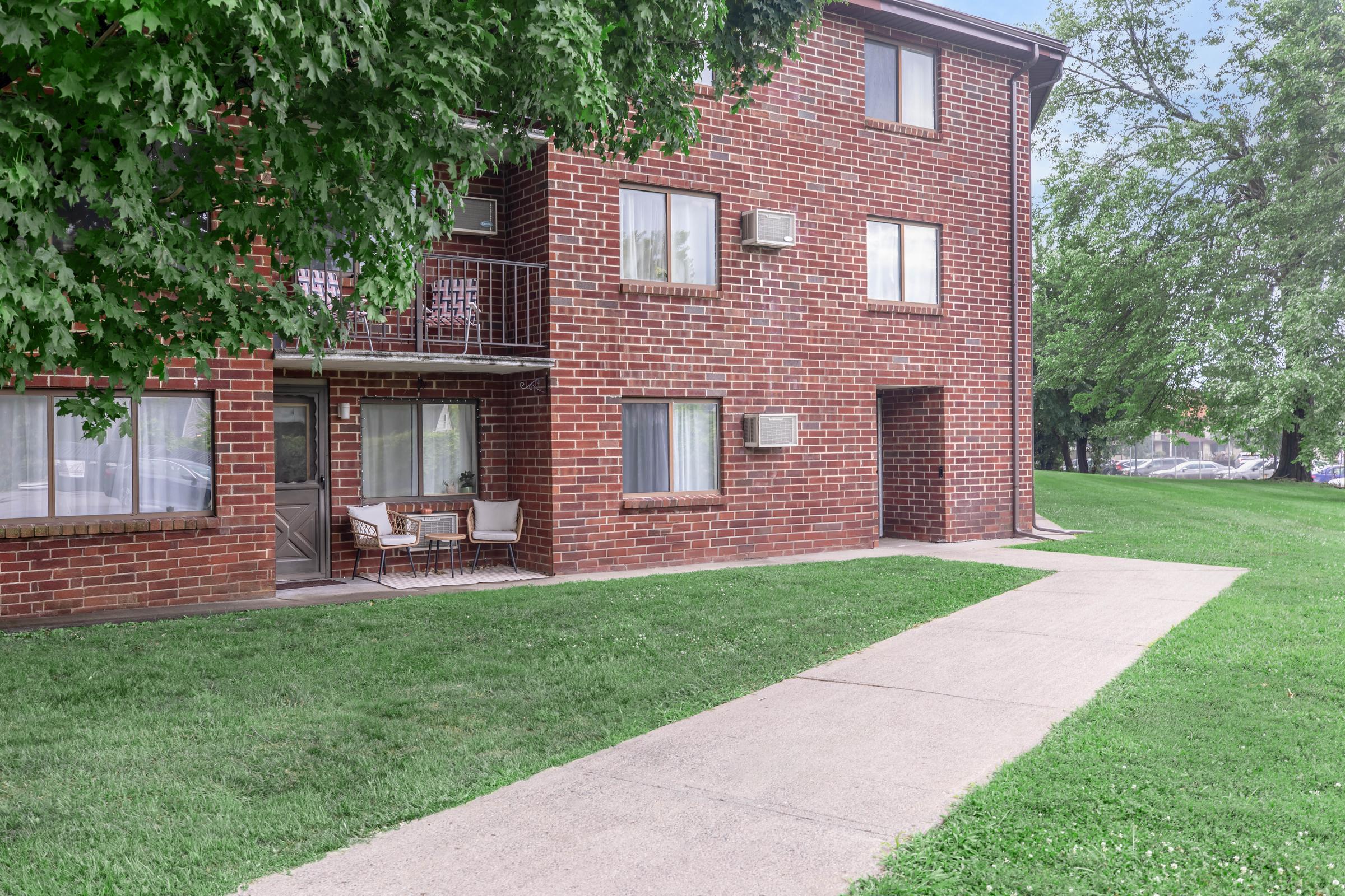 a large lawn in front of a brick building