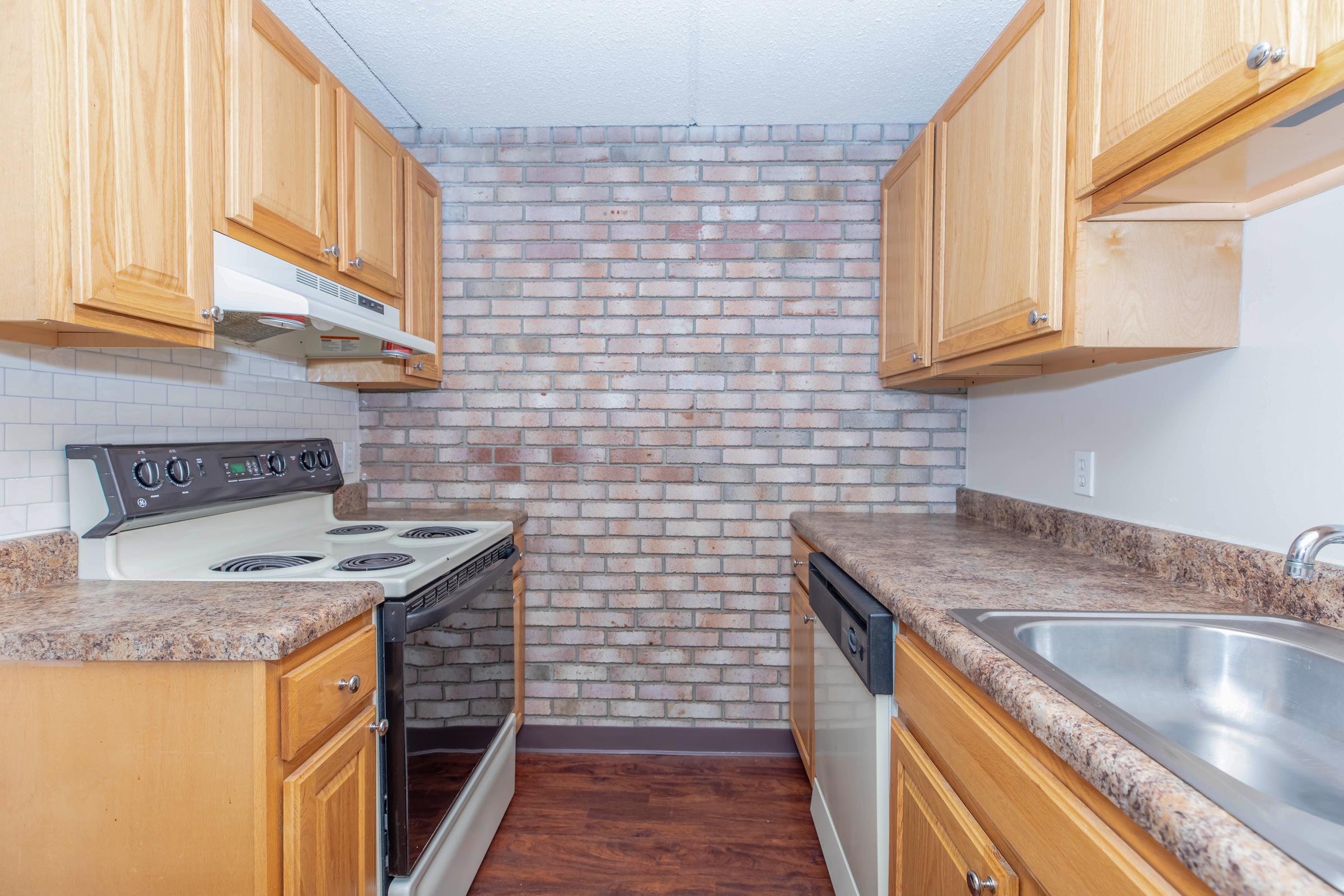 a kitchen with stainless steel appliances and wooden cabinets