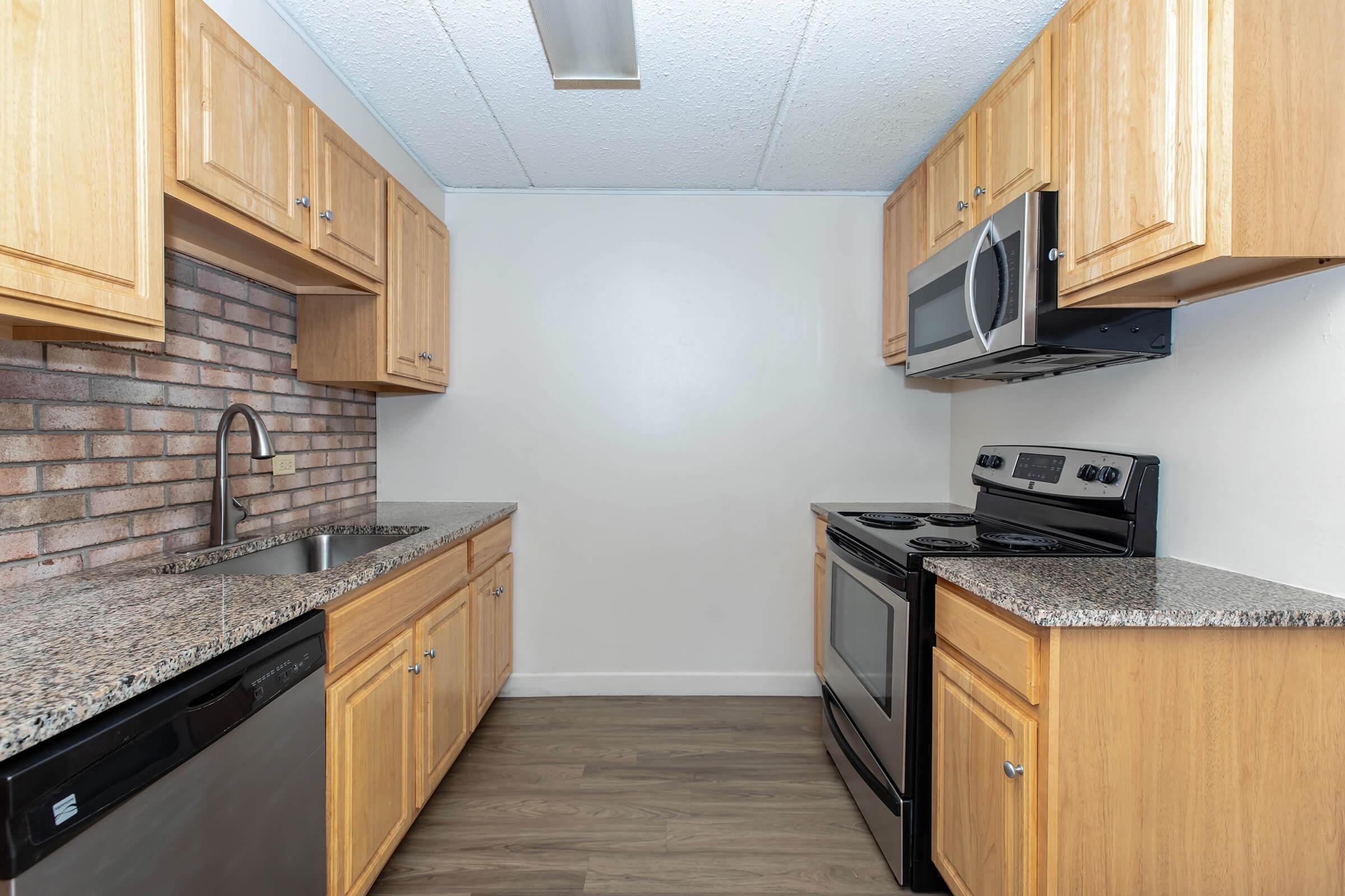 a kitchen with stainless steel appliances and wooden cabinets