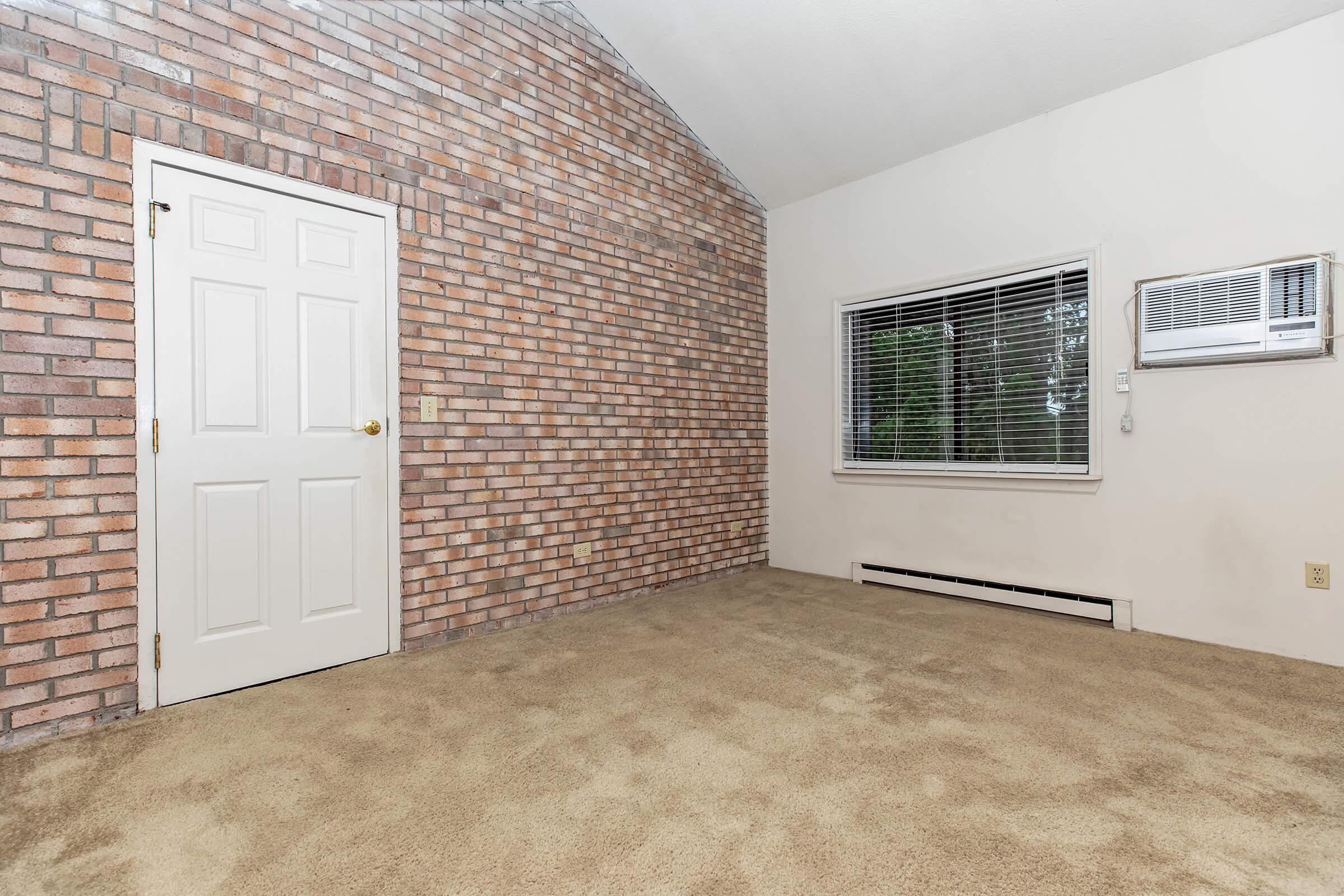 a living room in front of a brick building