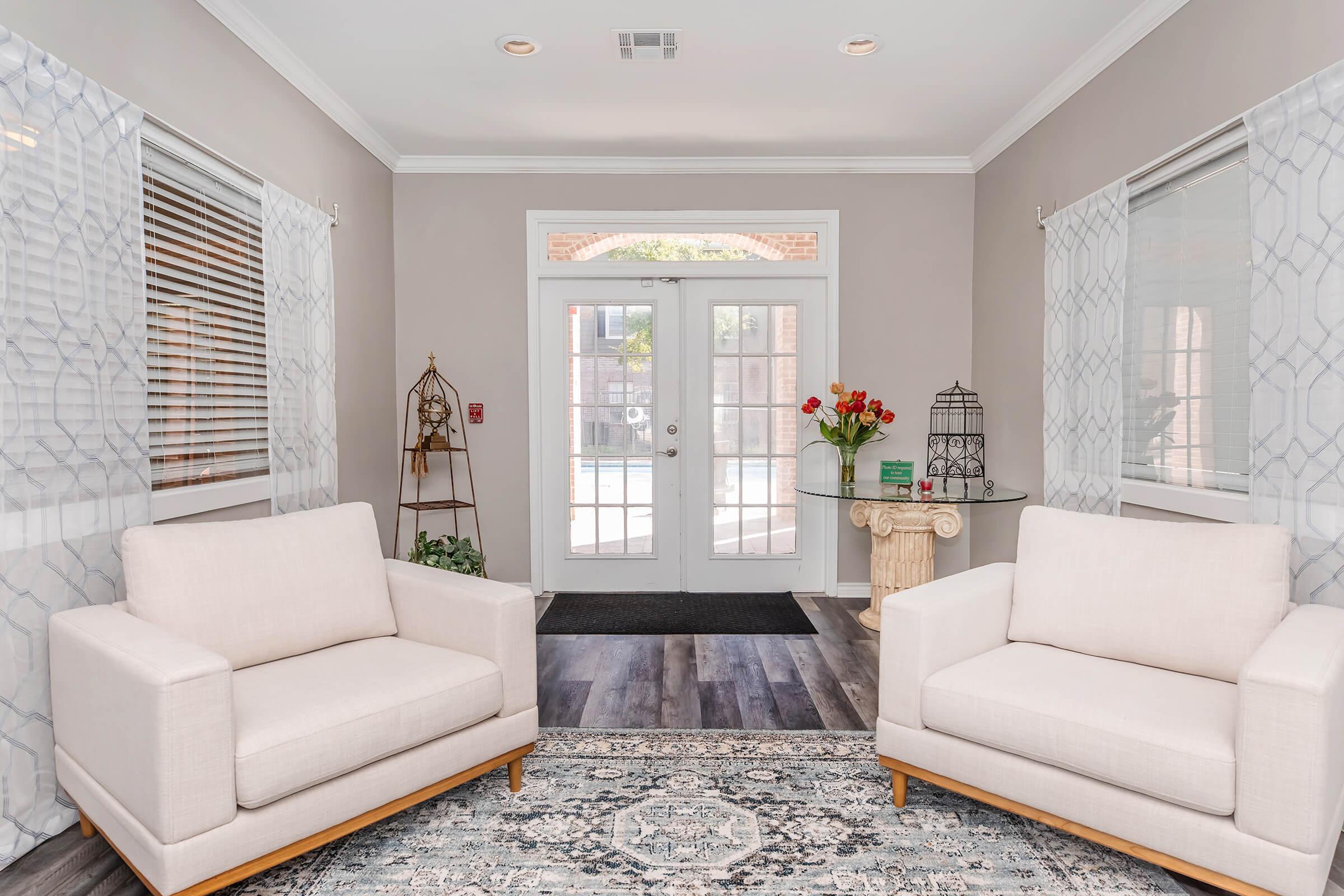 a living room filled with furniture and a large window