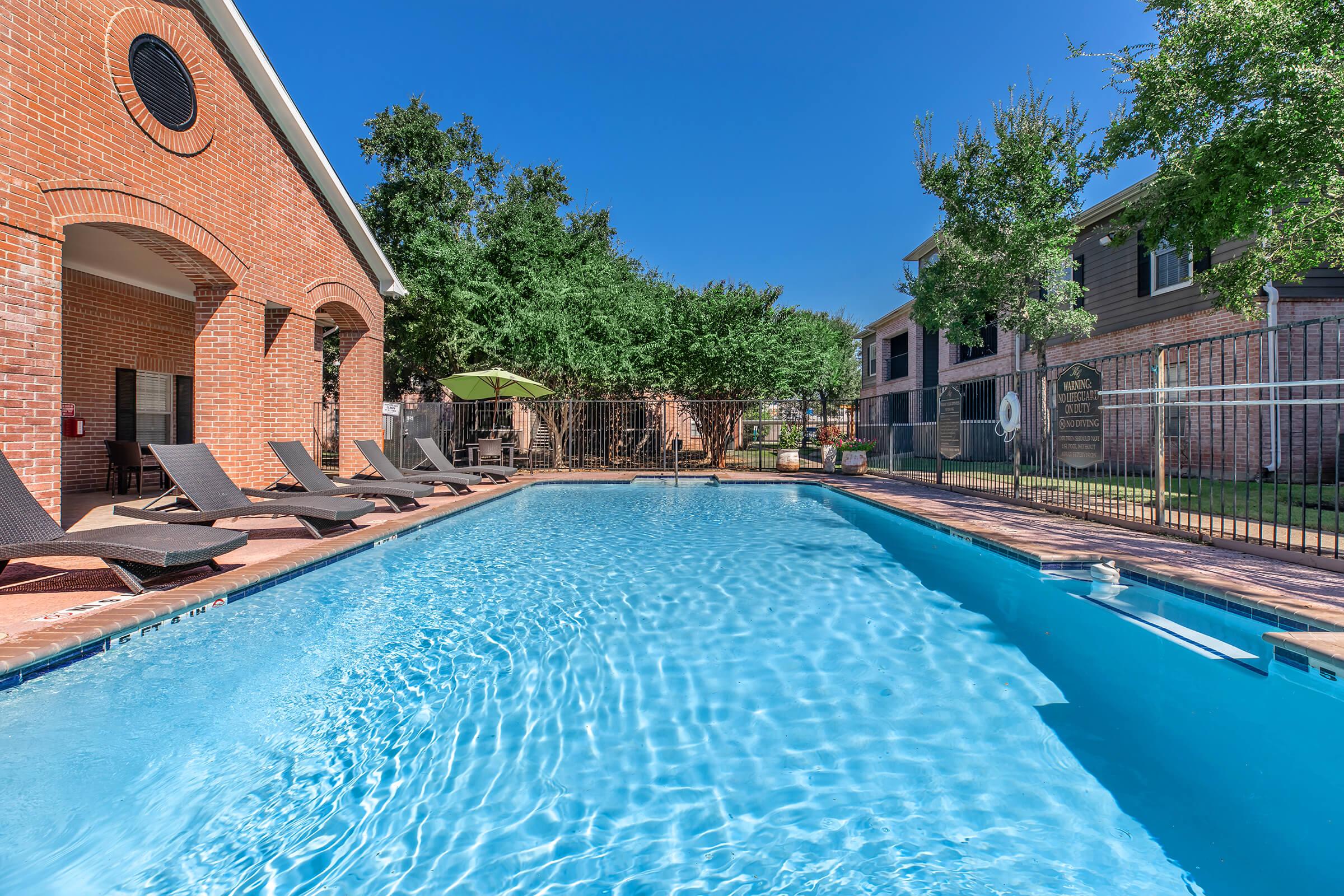 a house with a pool in front of a building