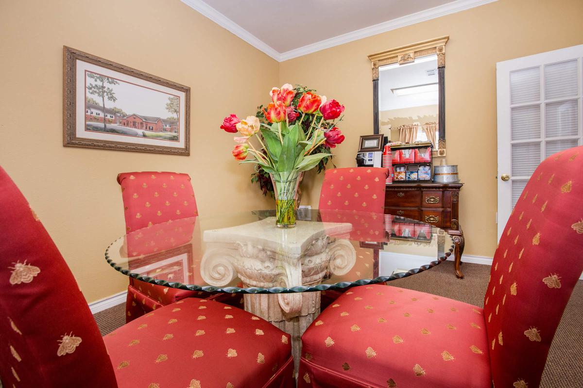 a living room filled with furniture and vase of flowers on a table