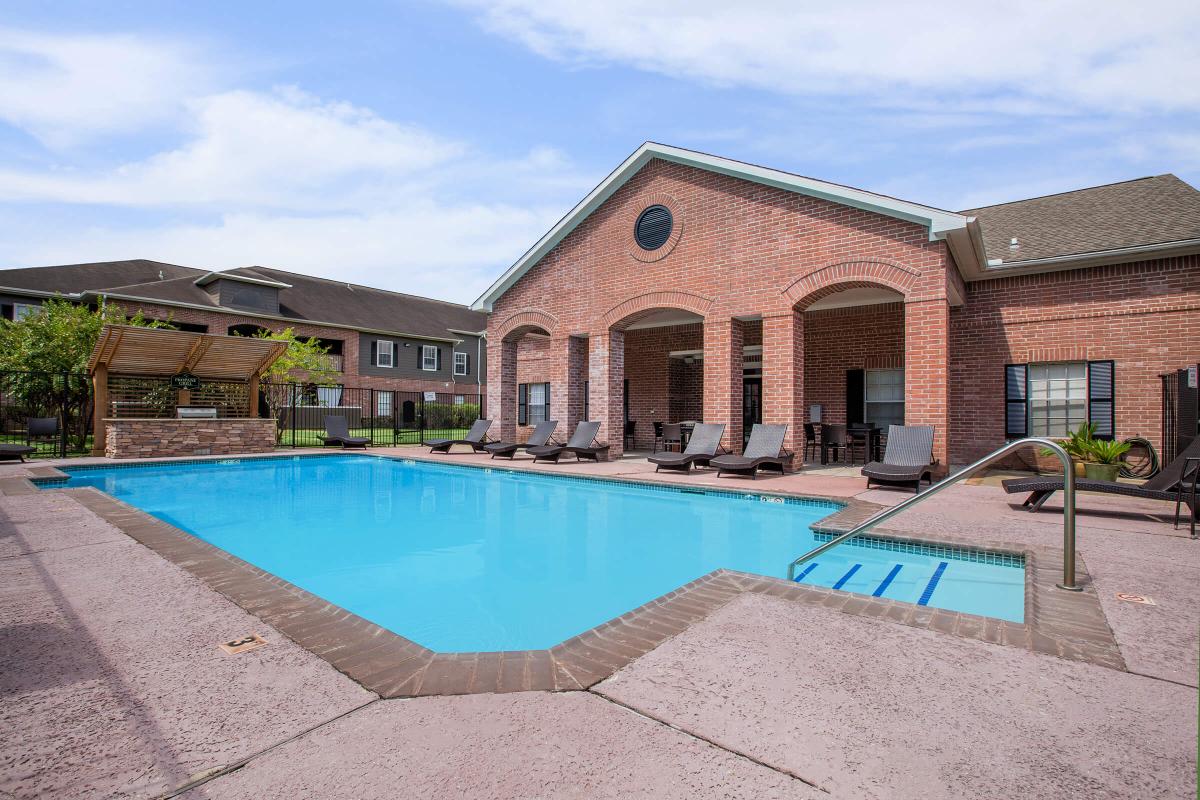 a building with a pool in front of a house