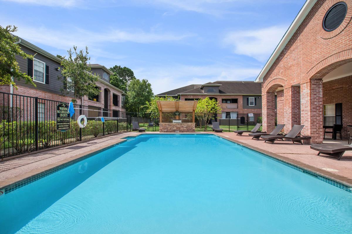 a house with a pool in front of a building