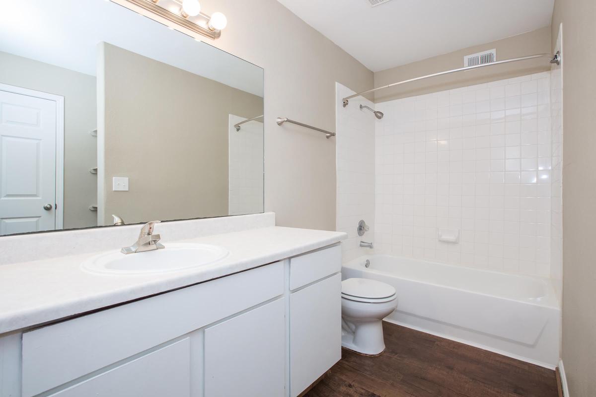 a large white tub sitting next to a sink