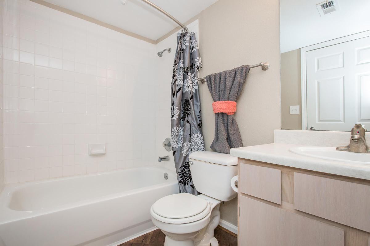 a white tub sitting next to a shower