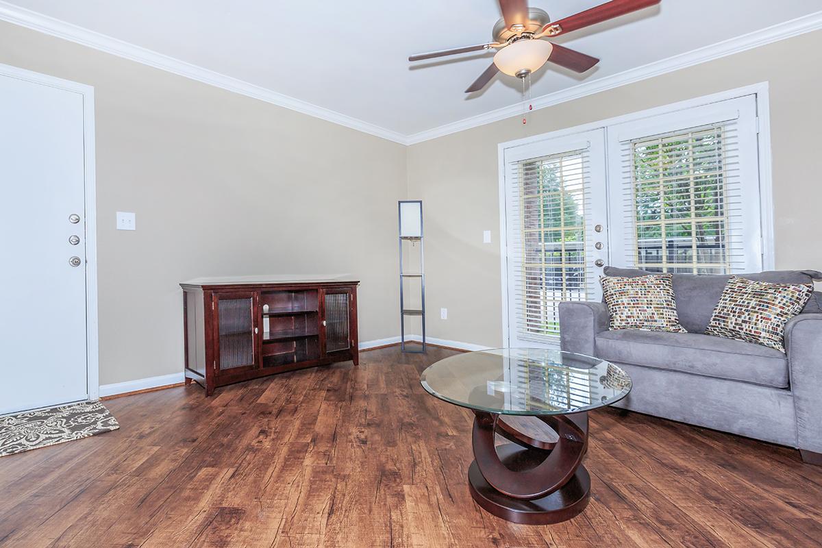 a living room filled with furniture and a large window