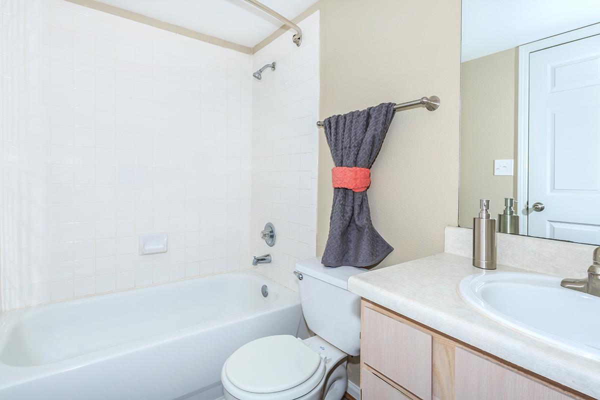 a large white tub sitting next to a sink