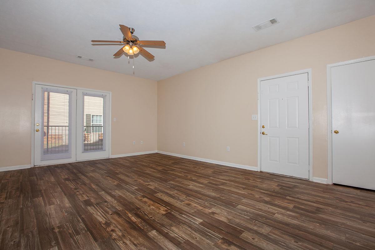 a large empty room with a wood floor