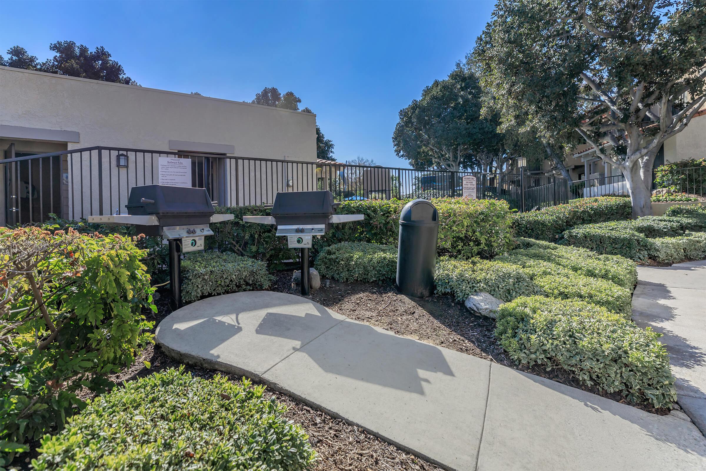 Barbecues surrounded by green shrubs