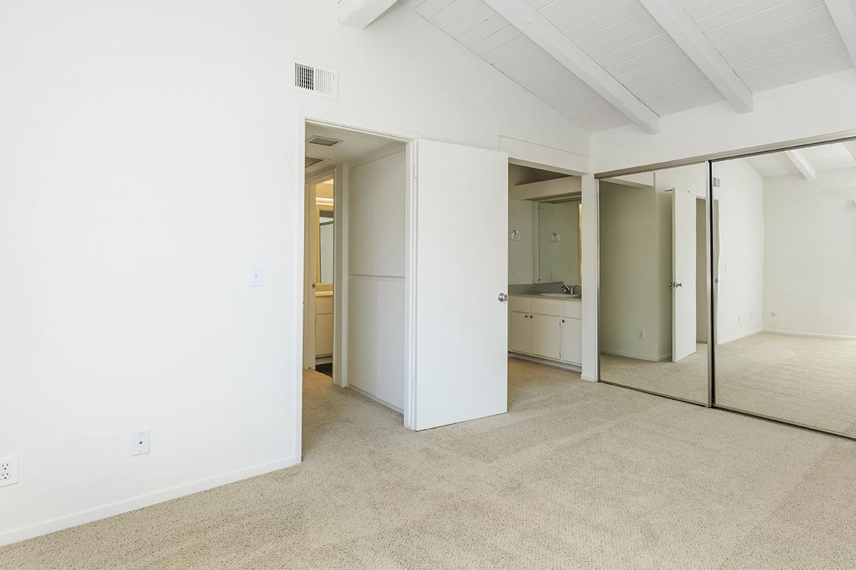 Bedroom with sliding mirror glass closet doors