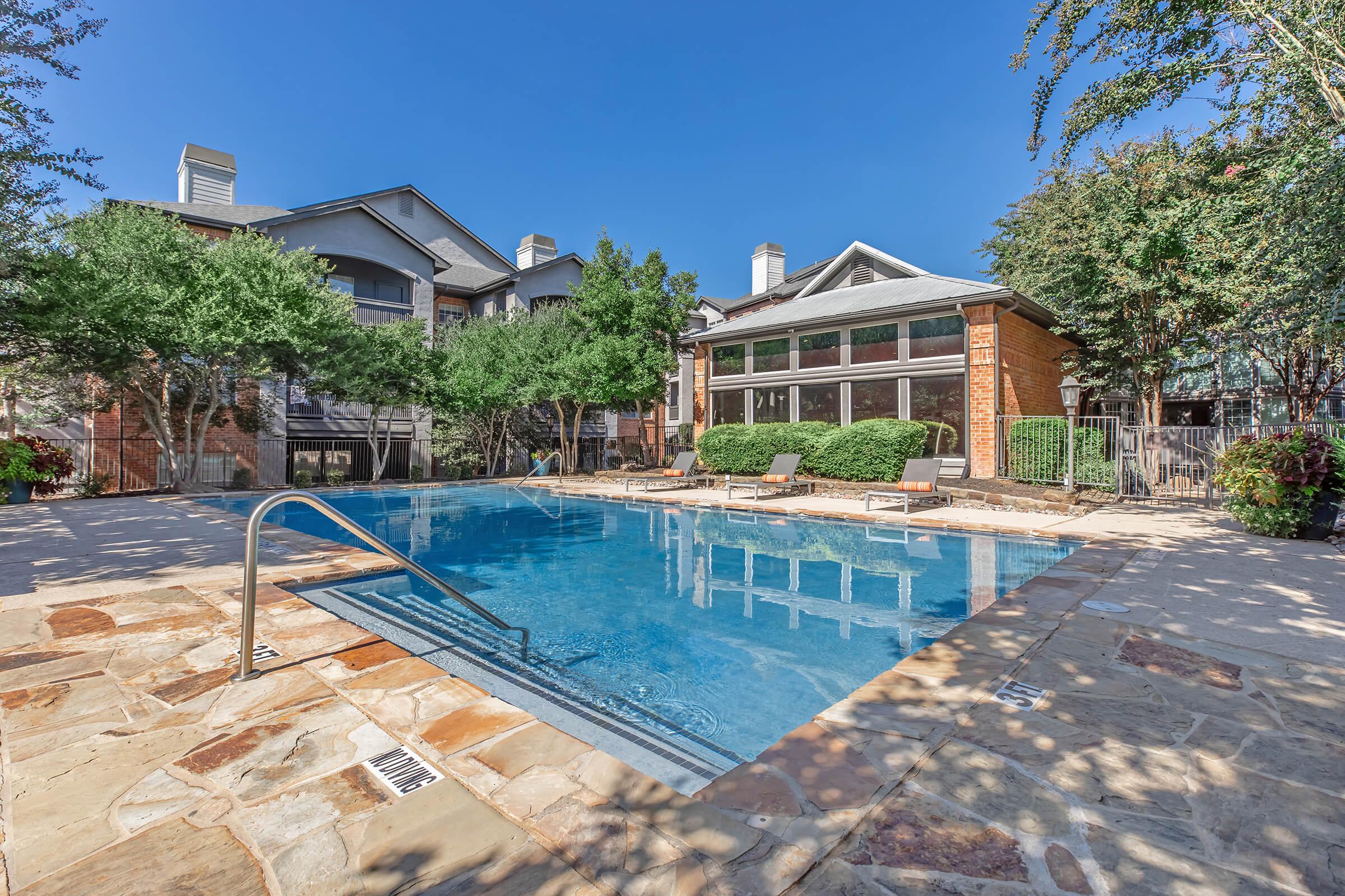 a house with a pool in front of a building