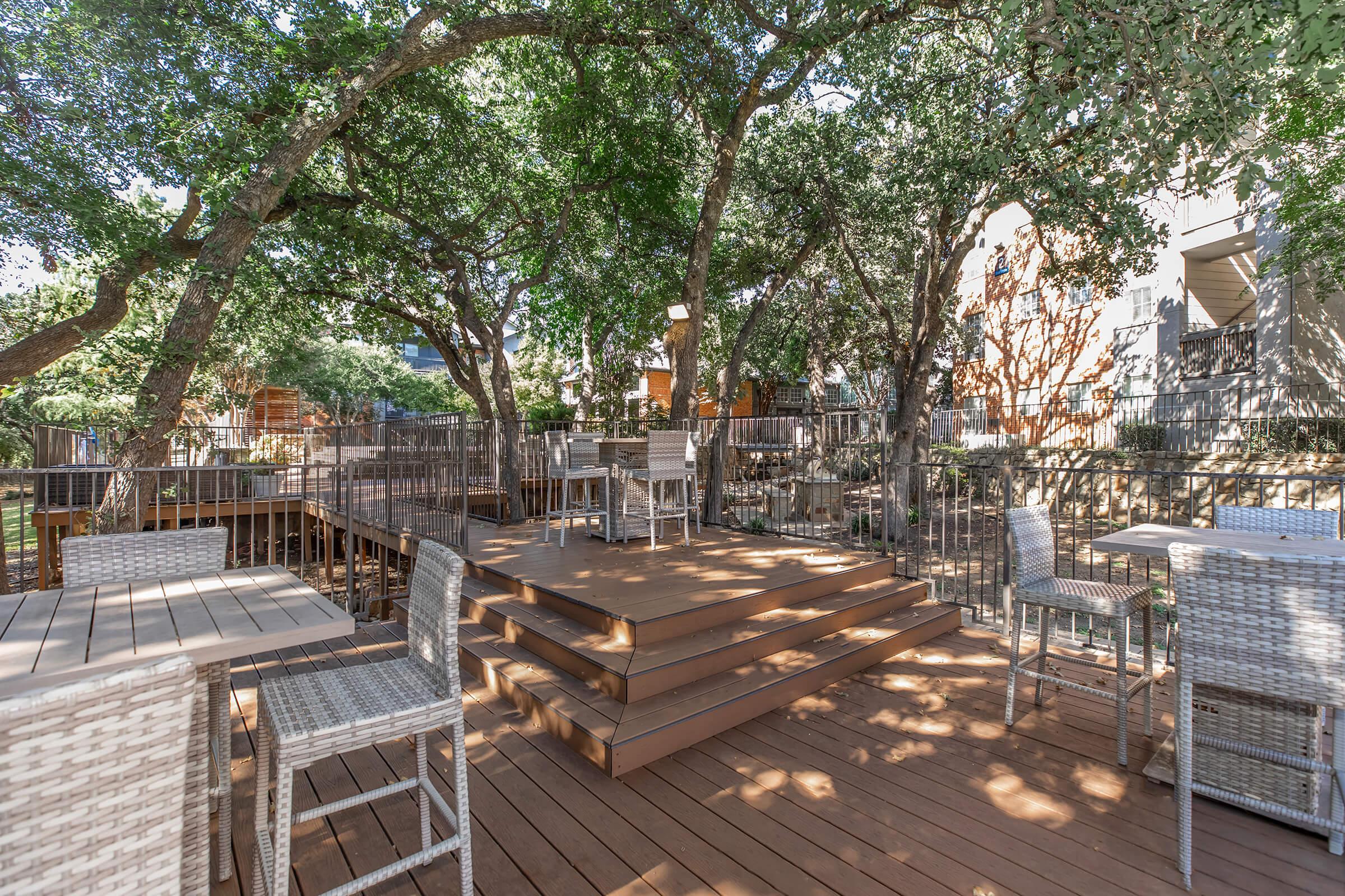 a wooden bench sitting next to a fence