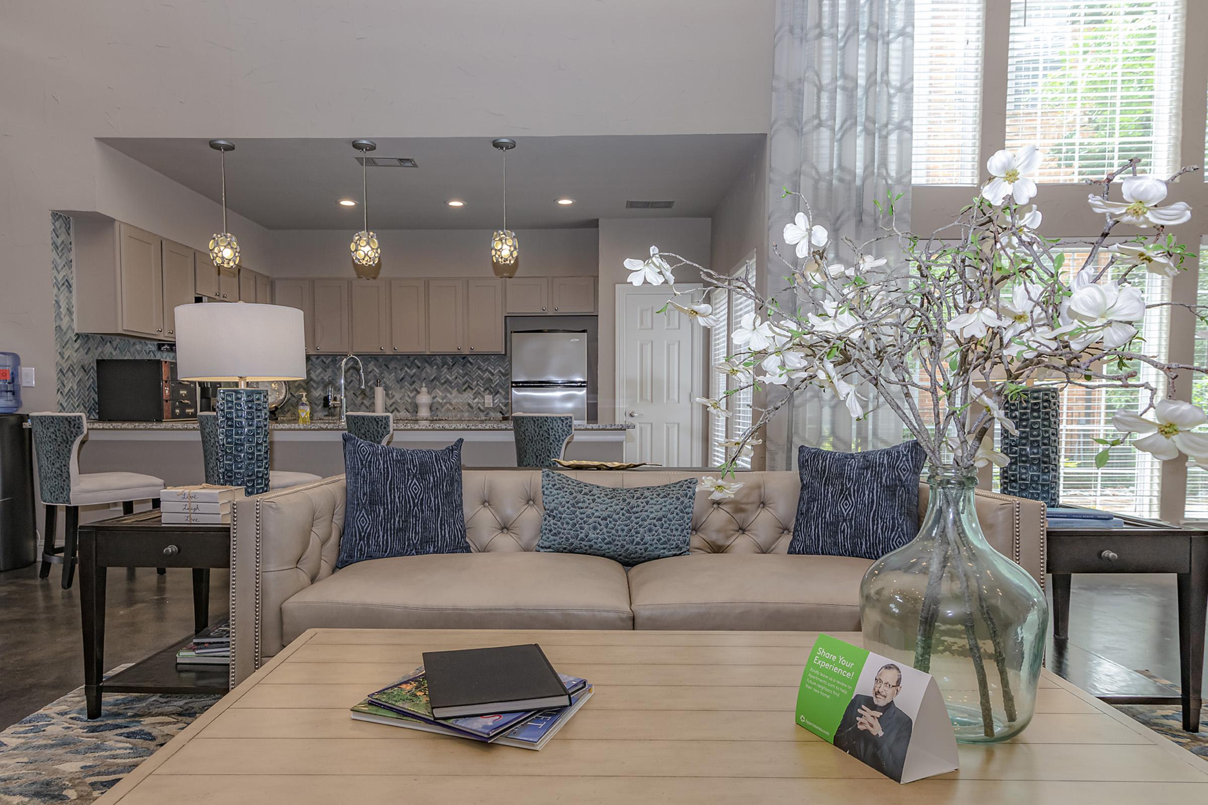 a living room filled with furniture and a large window