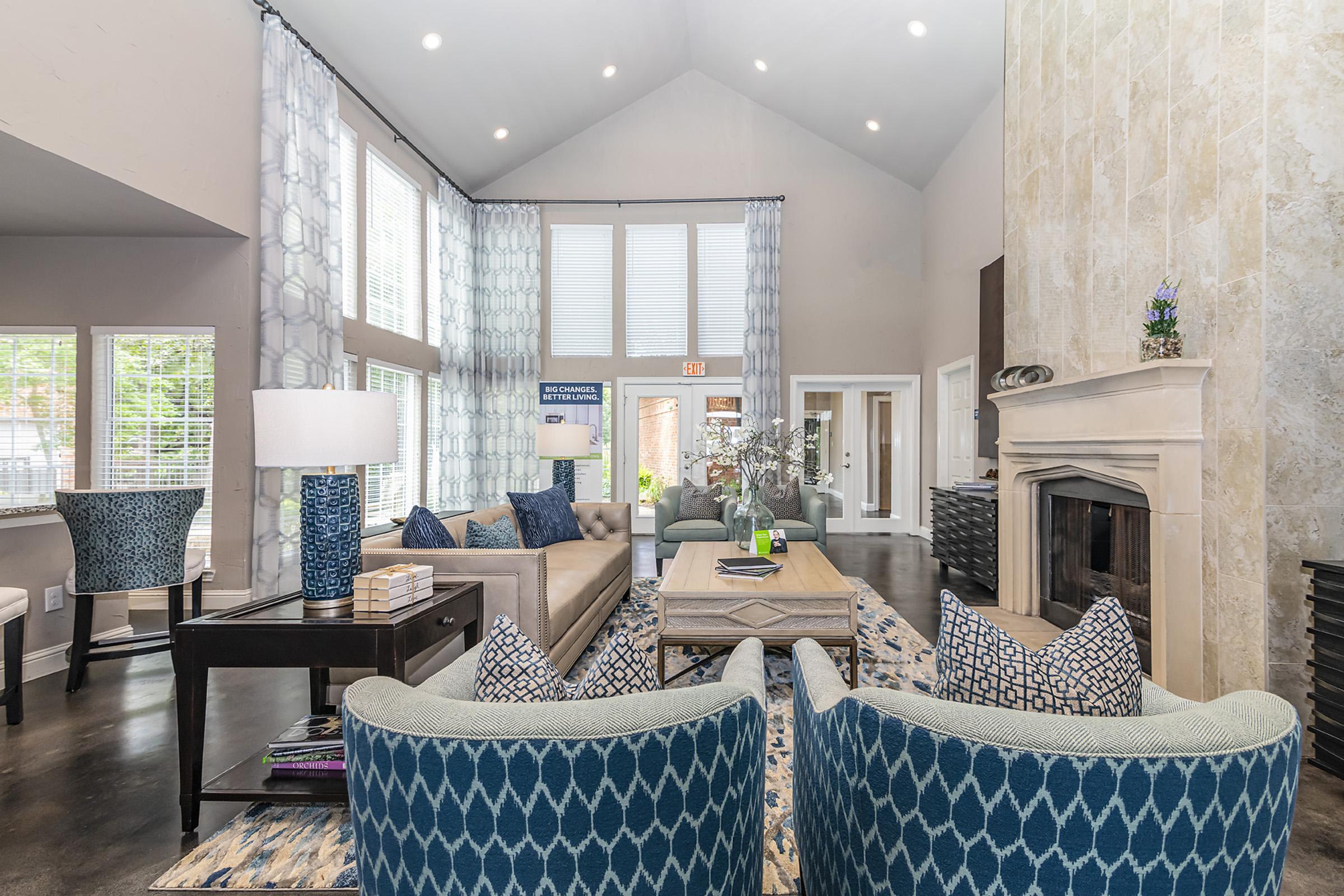 a living room filled with furniture and a large window