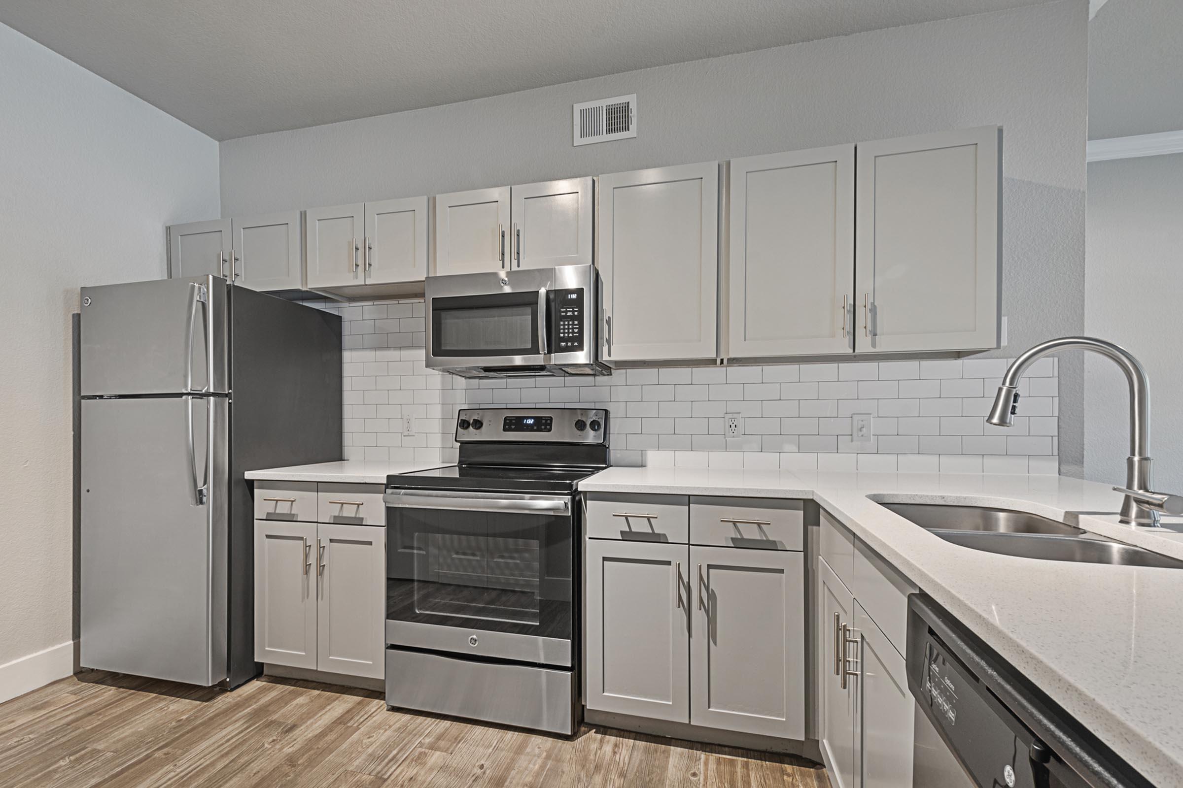 a large kitchen with stainless steel appliances