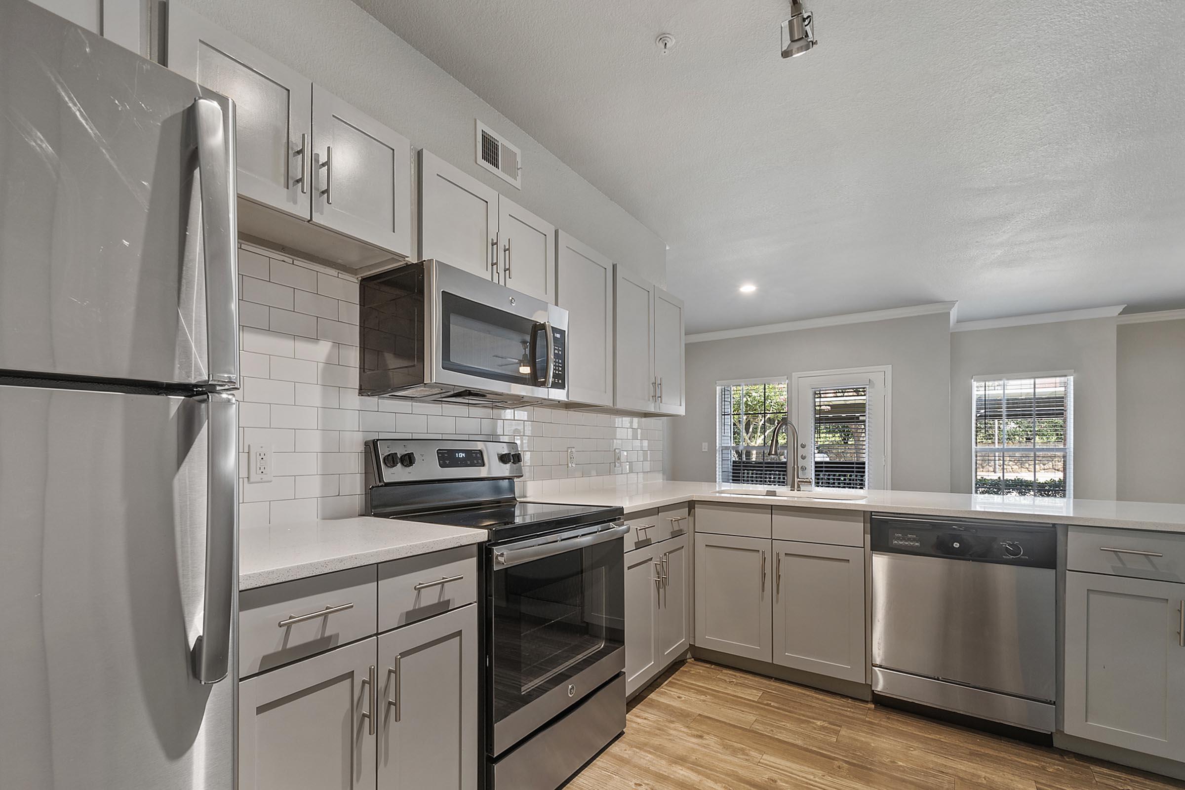 a kitchen with a stove and a refrigerator