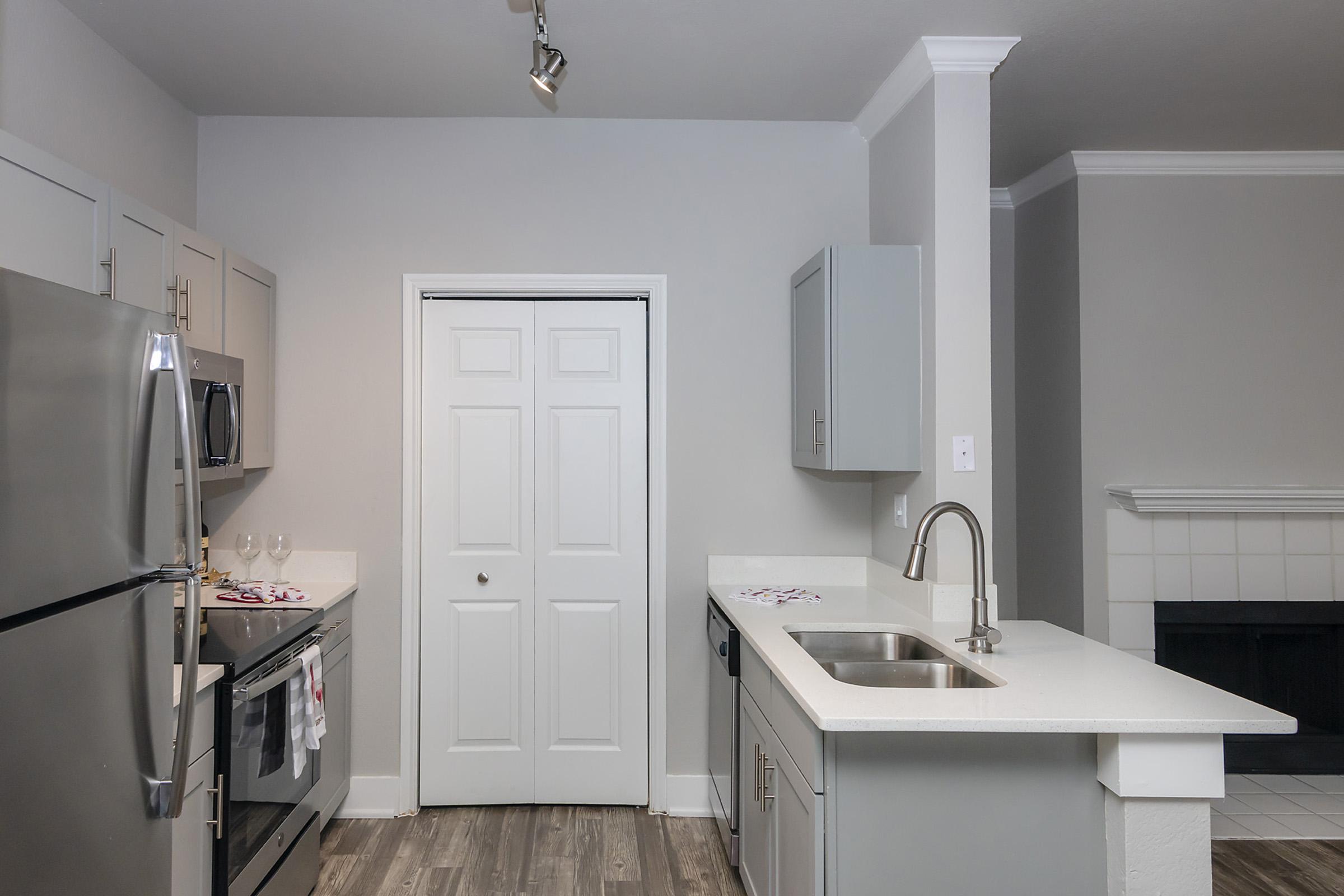 a kitchen with a sink and a mirror