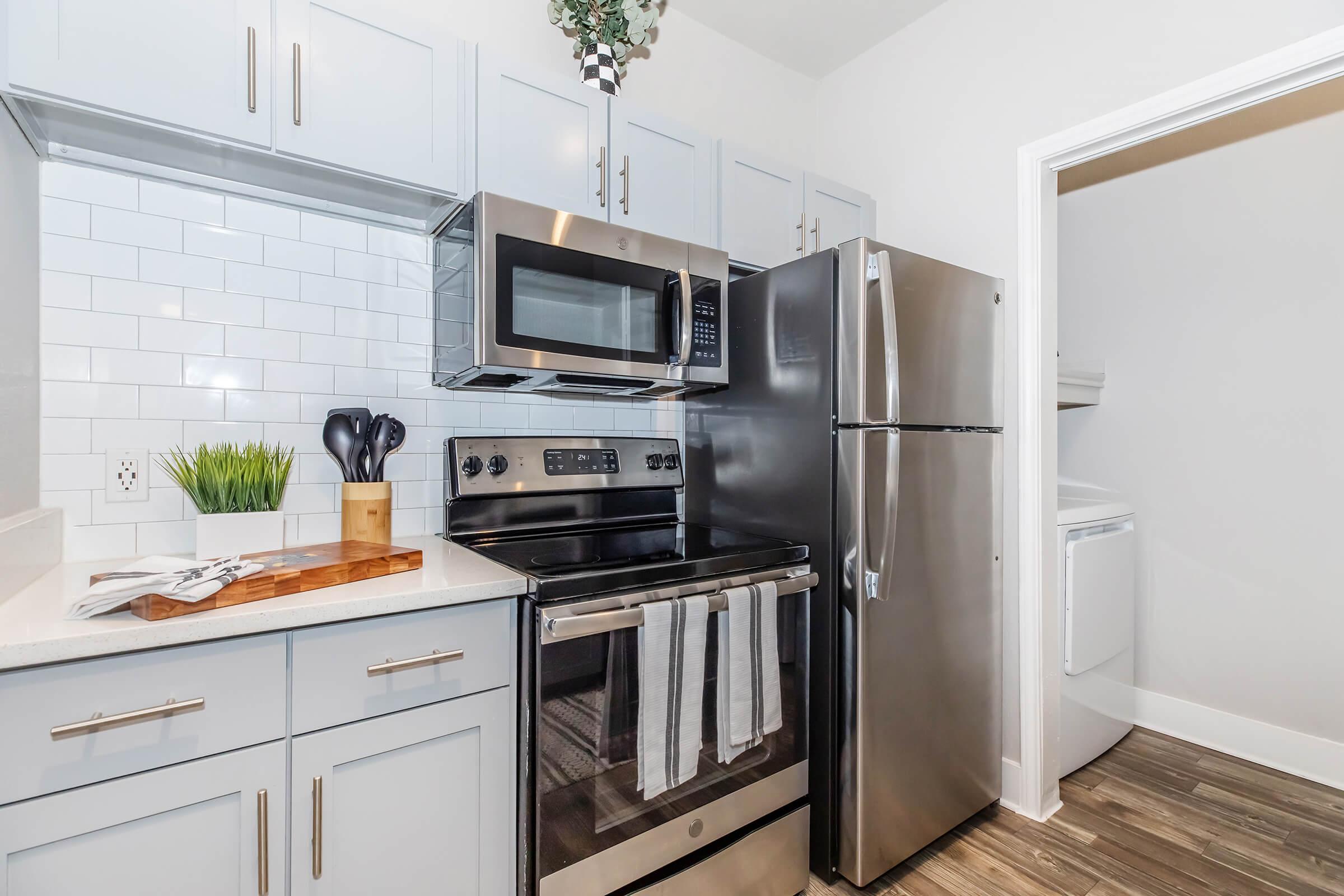 a stove top oven sitting inside of a kitchen