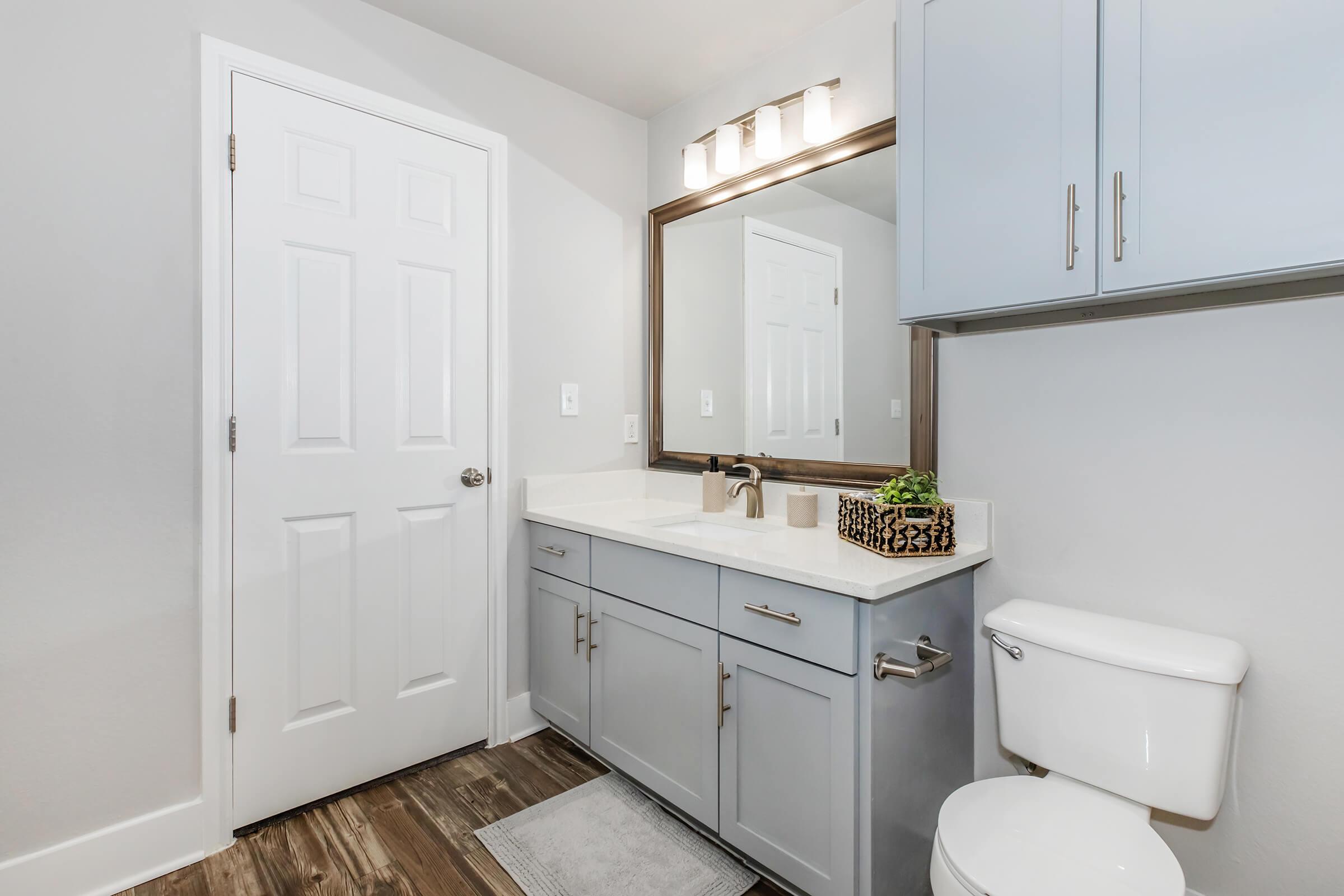 a kitchen with a sink and a mirror