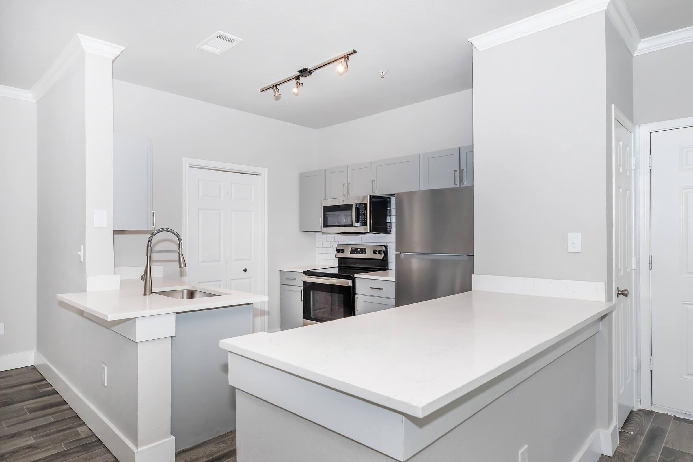 a kitchen with a sink and a mirror