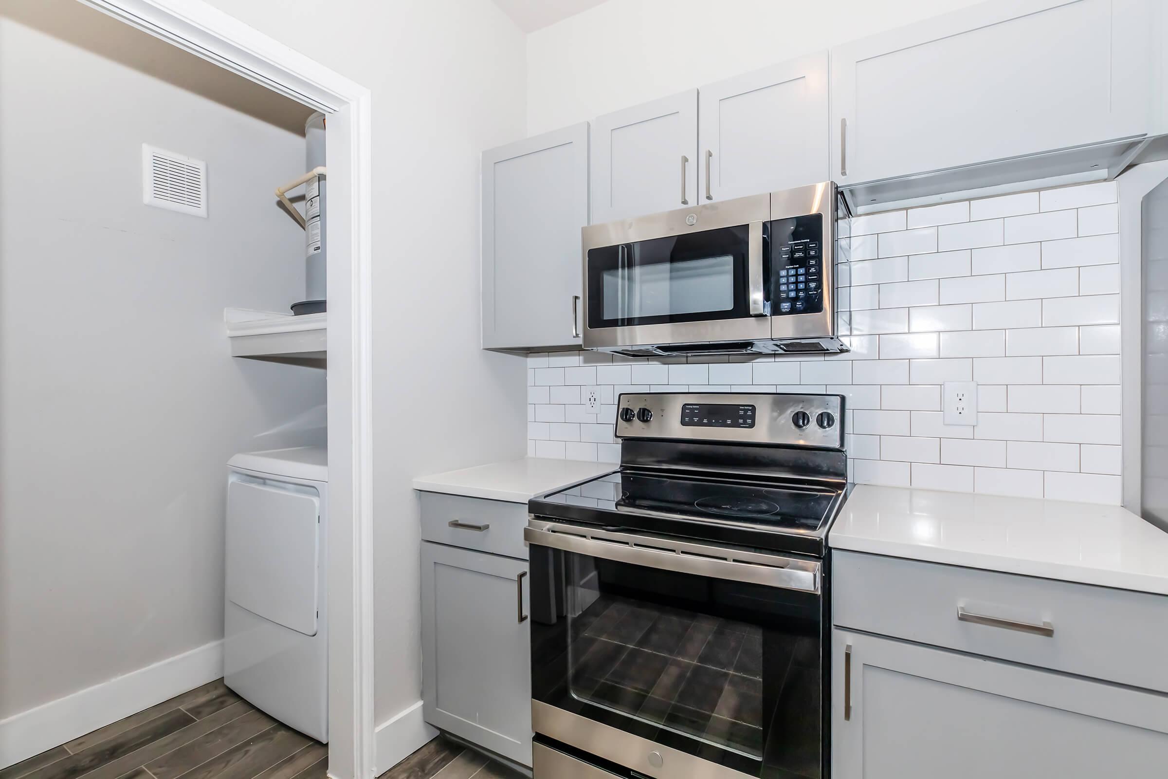 a stove top oven sitting inside of a kitchen