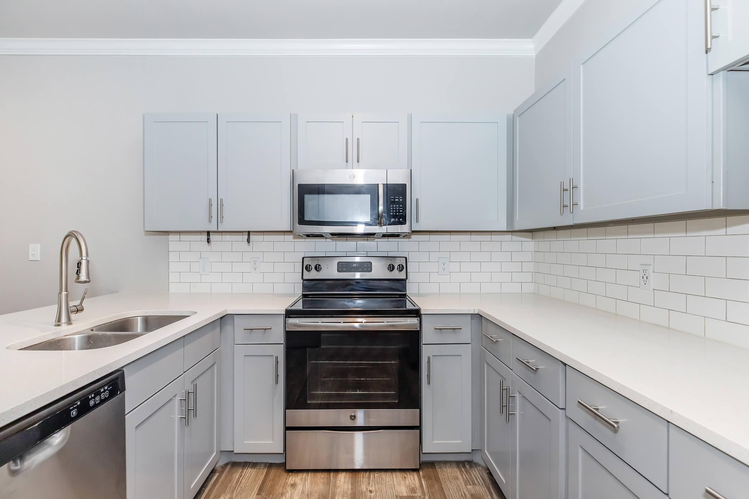 a kitchen with a sink and a microwave