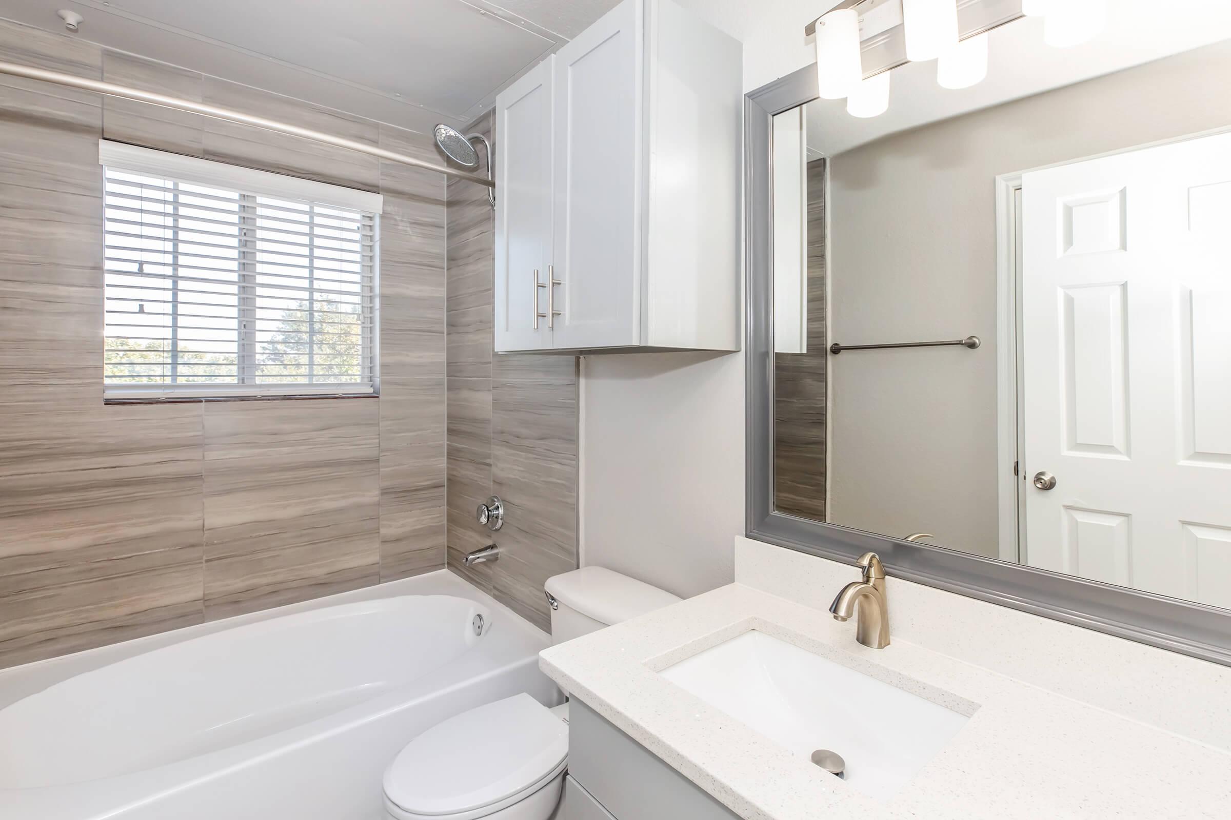 a kitchen with a sink mirror and window