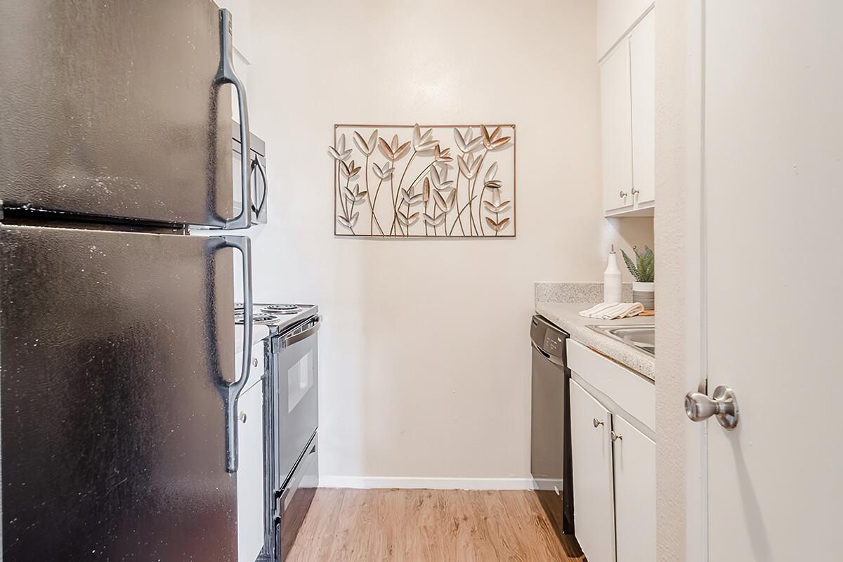 a kitchen with a sink and a refrigerator