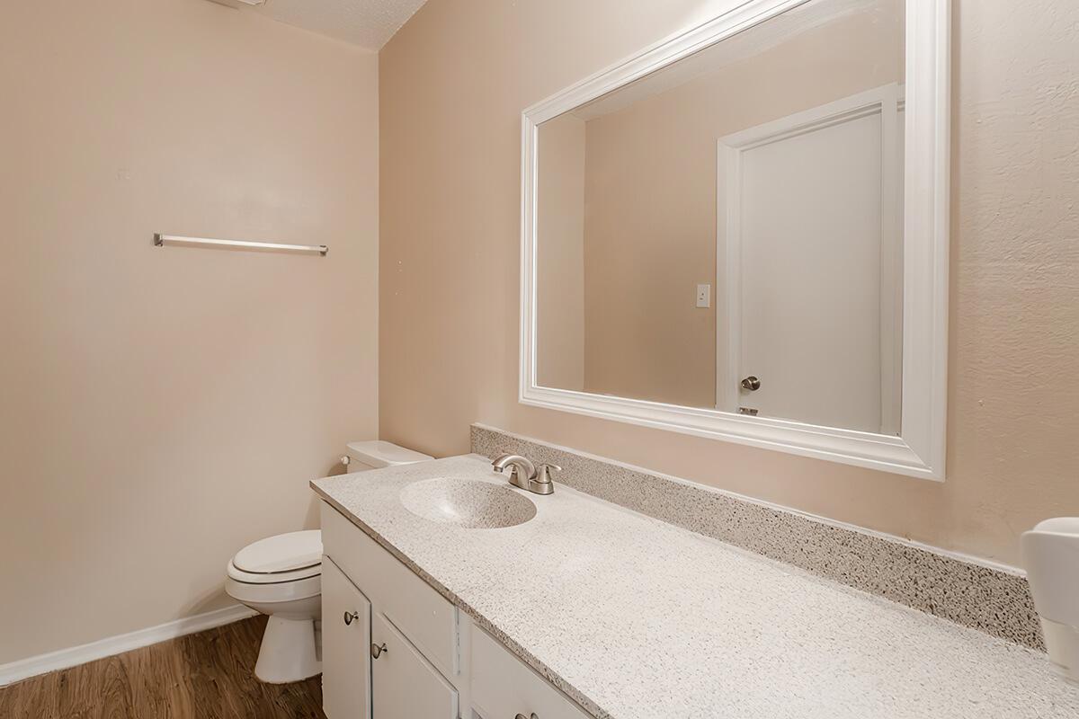 a hotel room with a sink and a mirror