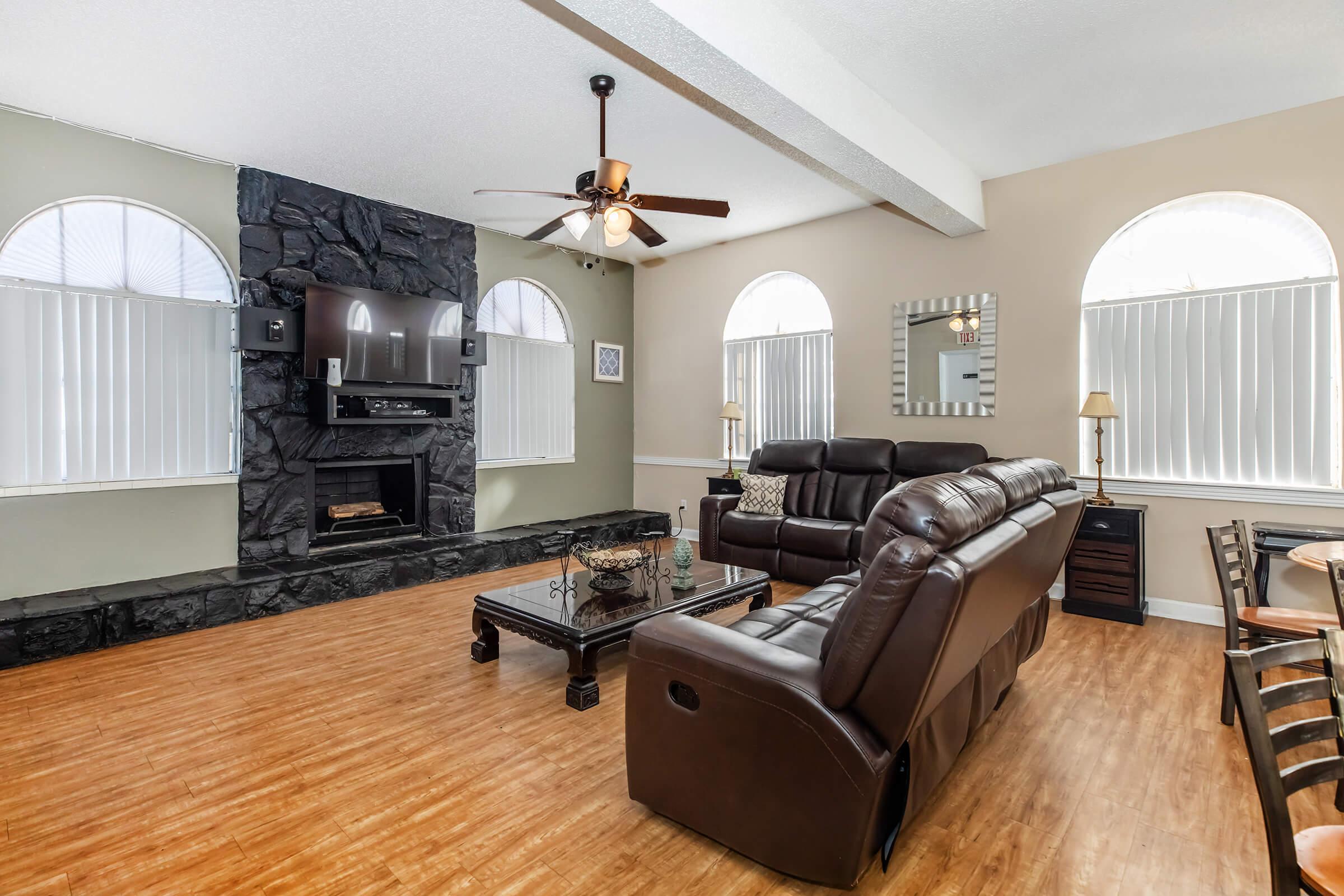 a living room filled with furniture and a large window