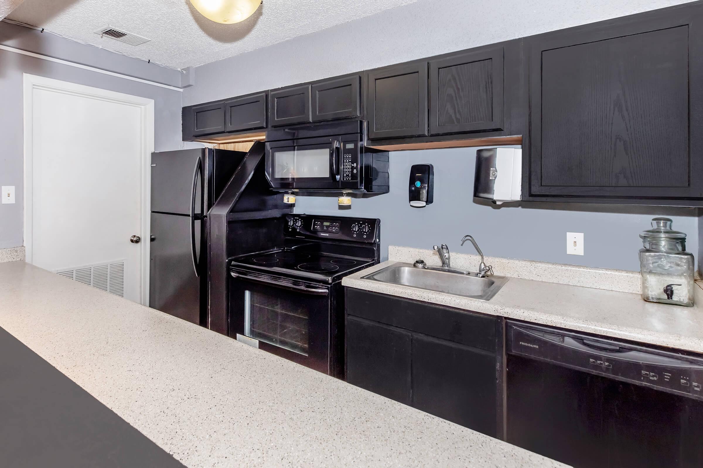 a large kitchen with stainless steel appliances