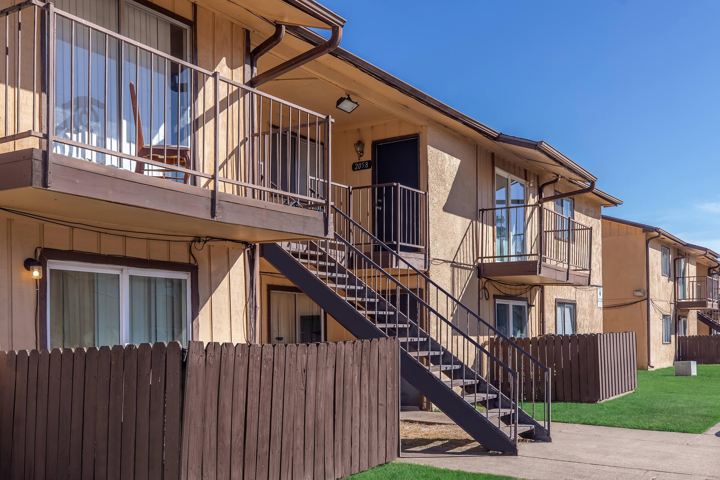 a house with a fence in front of a building