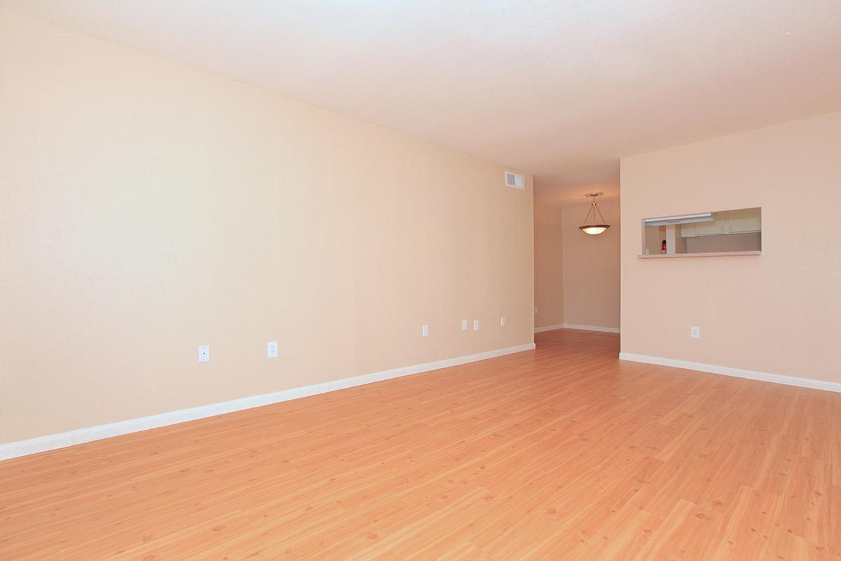 a large empty room with a wood floor