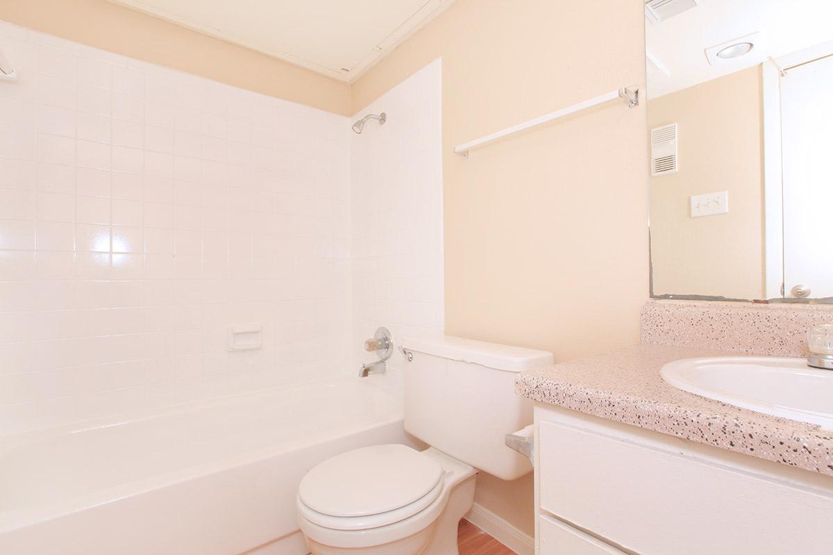 a white tub sitting next to a shower