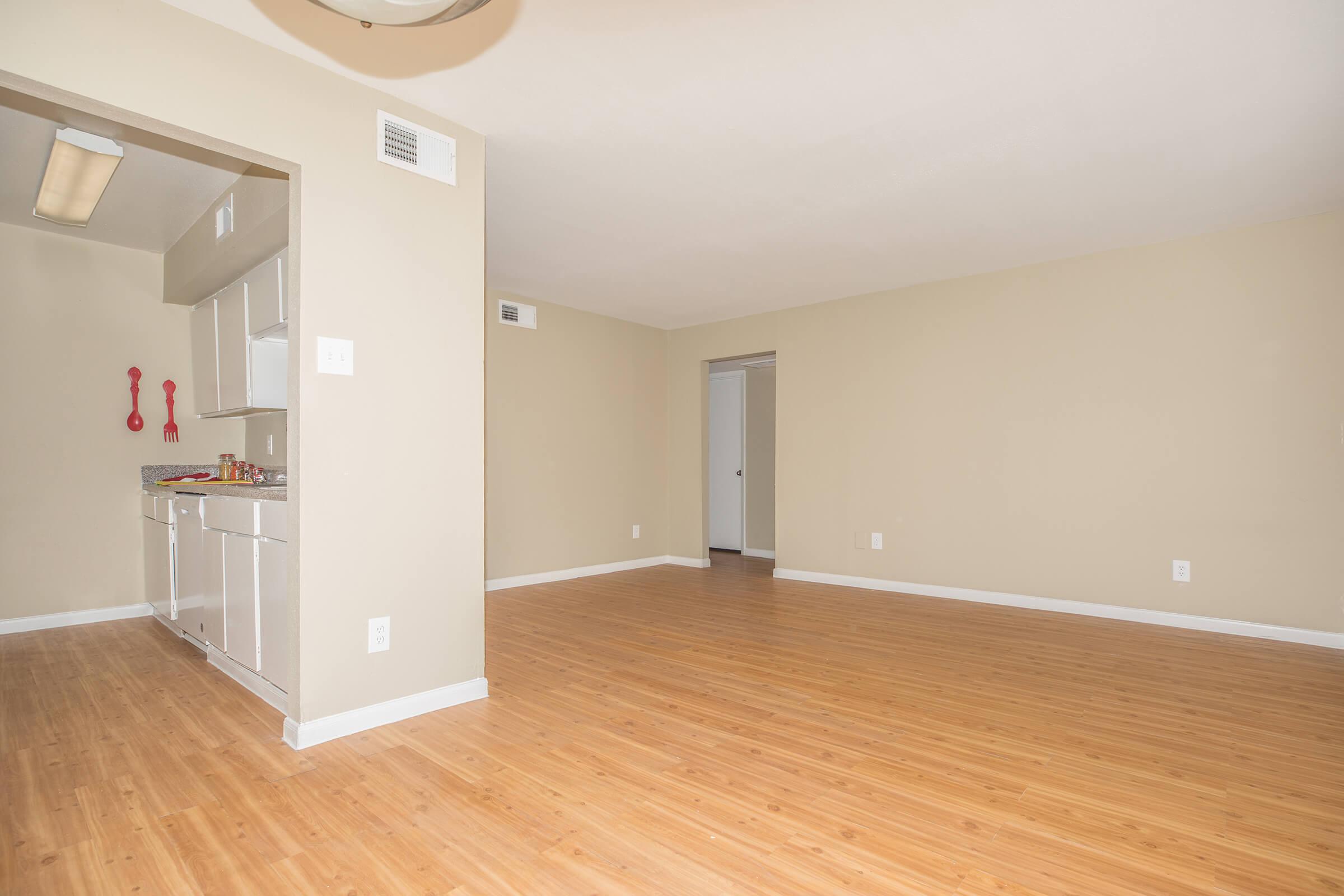 a large empty room with a wood floor