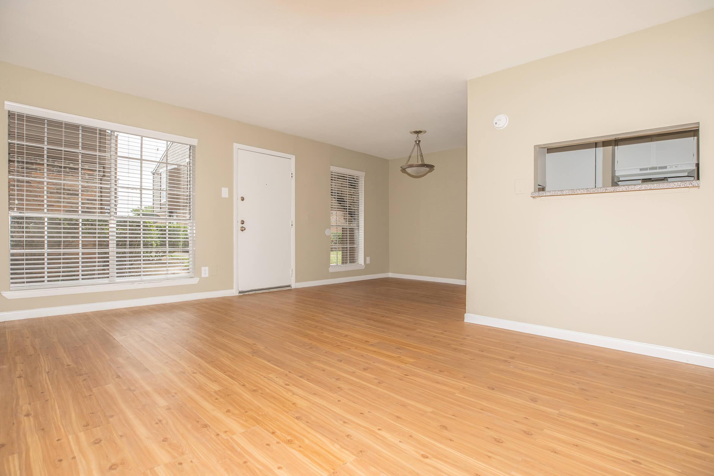 a large empty room with a wood floor