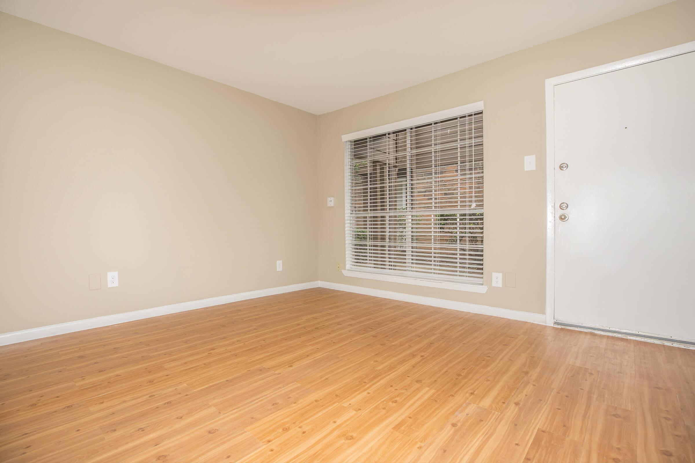 a large empty room with a wood floor