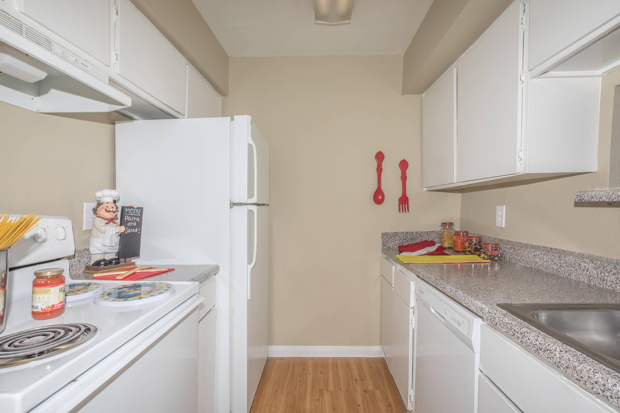 a white refrigerator freezer sitting inside of a kitchen