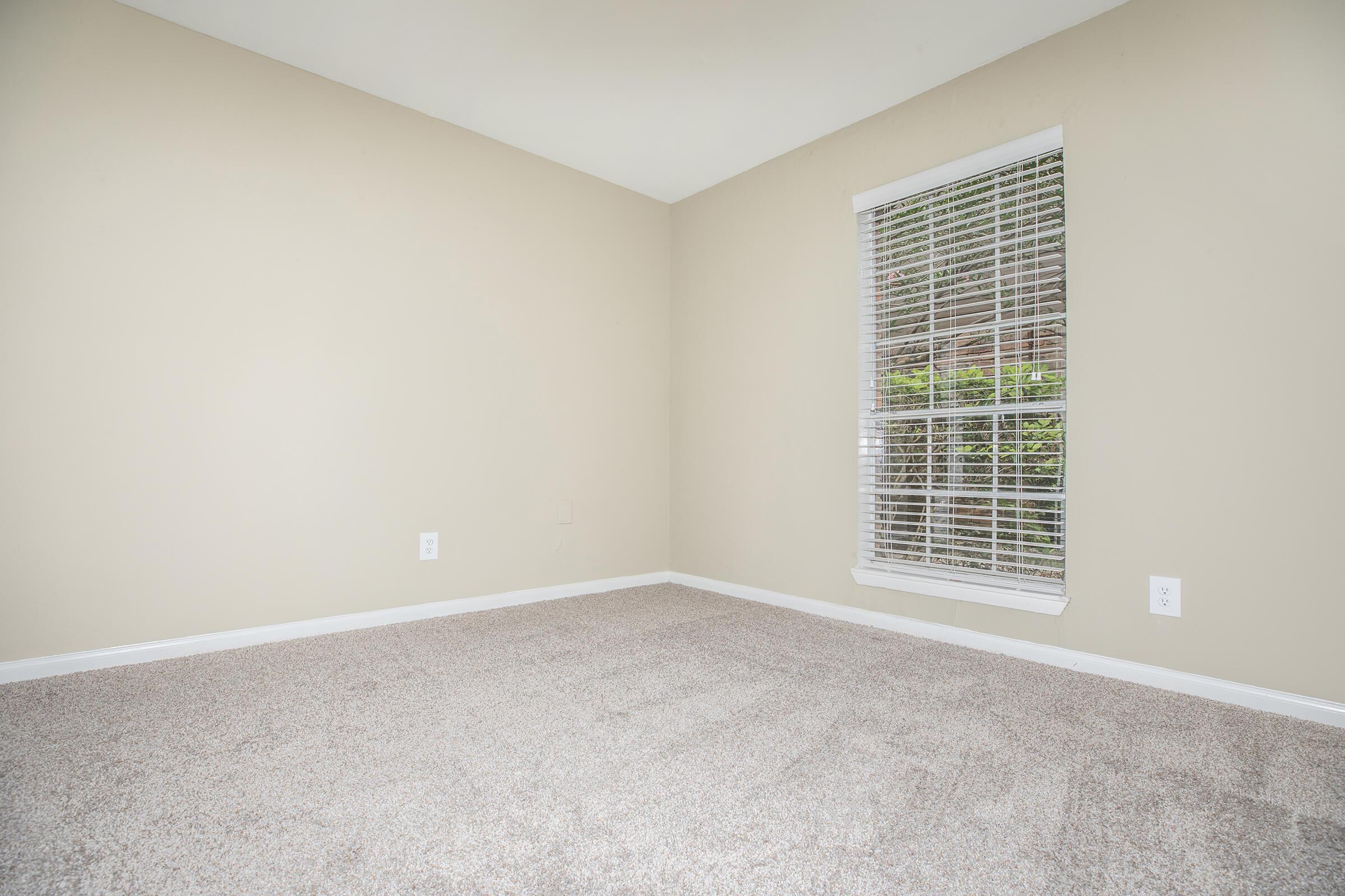 a close up of a bedroom next to a window