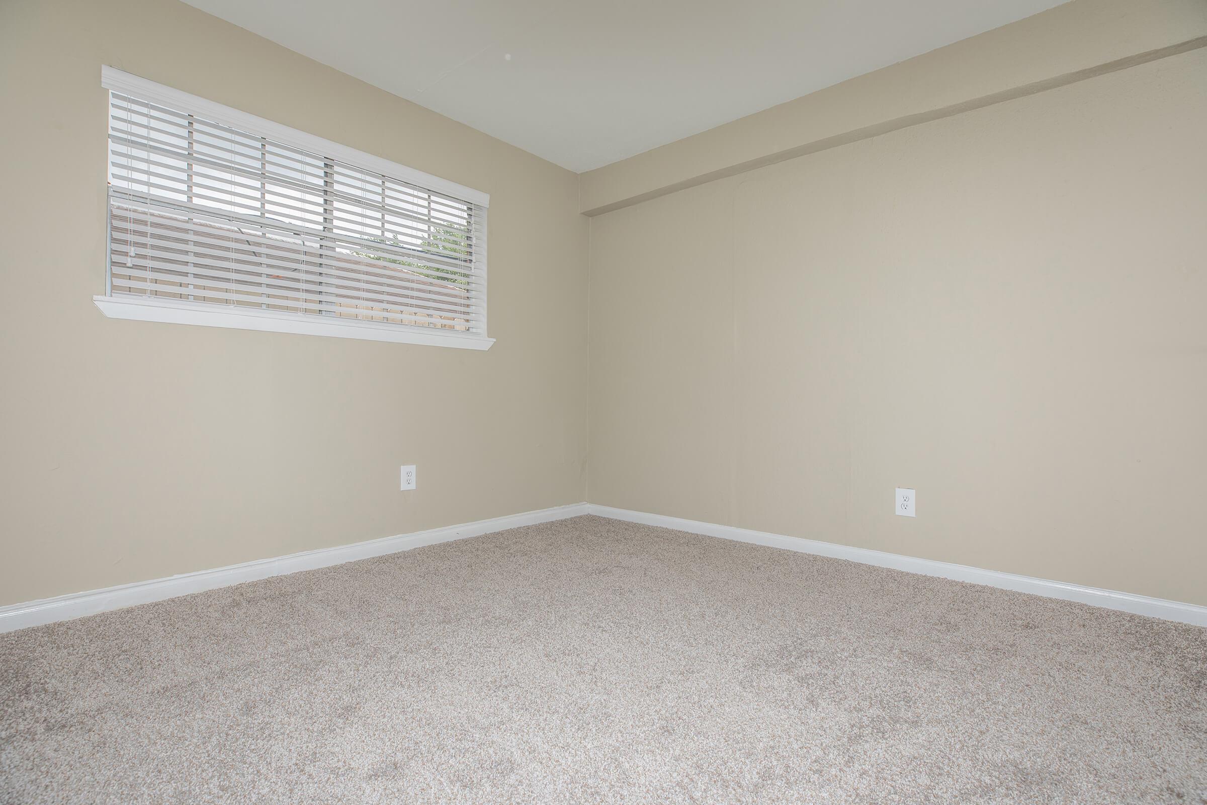 a bedroom with a large window